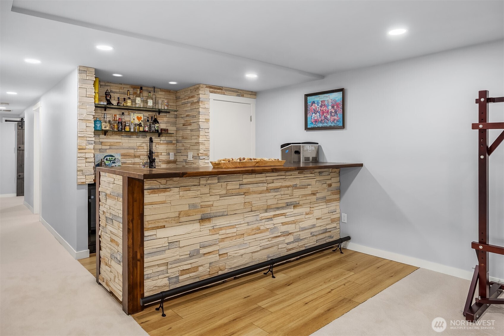 The highlight of the new lower family/great room is this stacked stone wet bar. Love the glazed wood top and trim. Seating space for many 'patrons'.