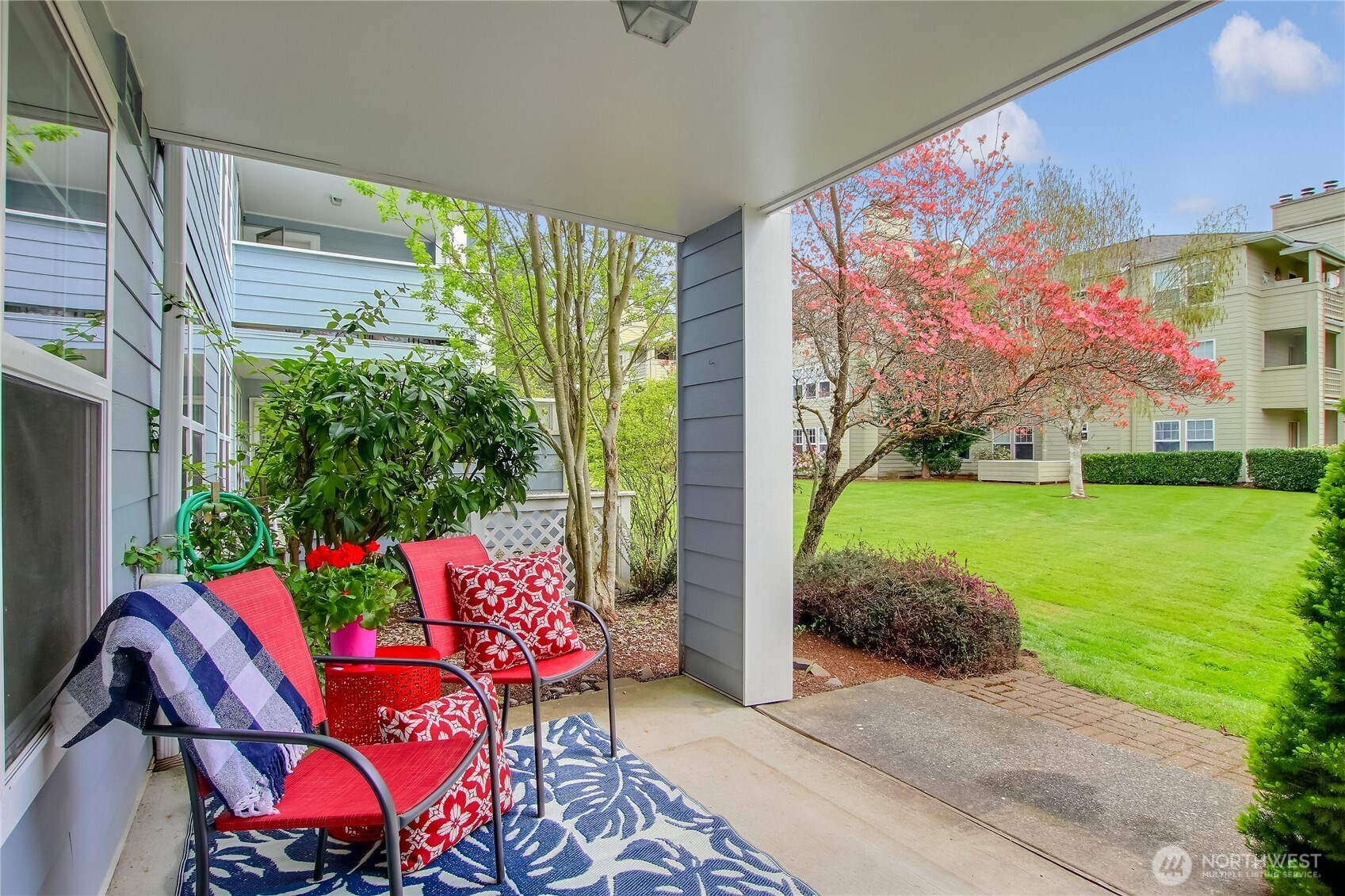 Back Patio faces open grassy area and landscaped grounds