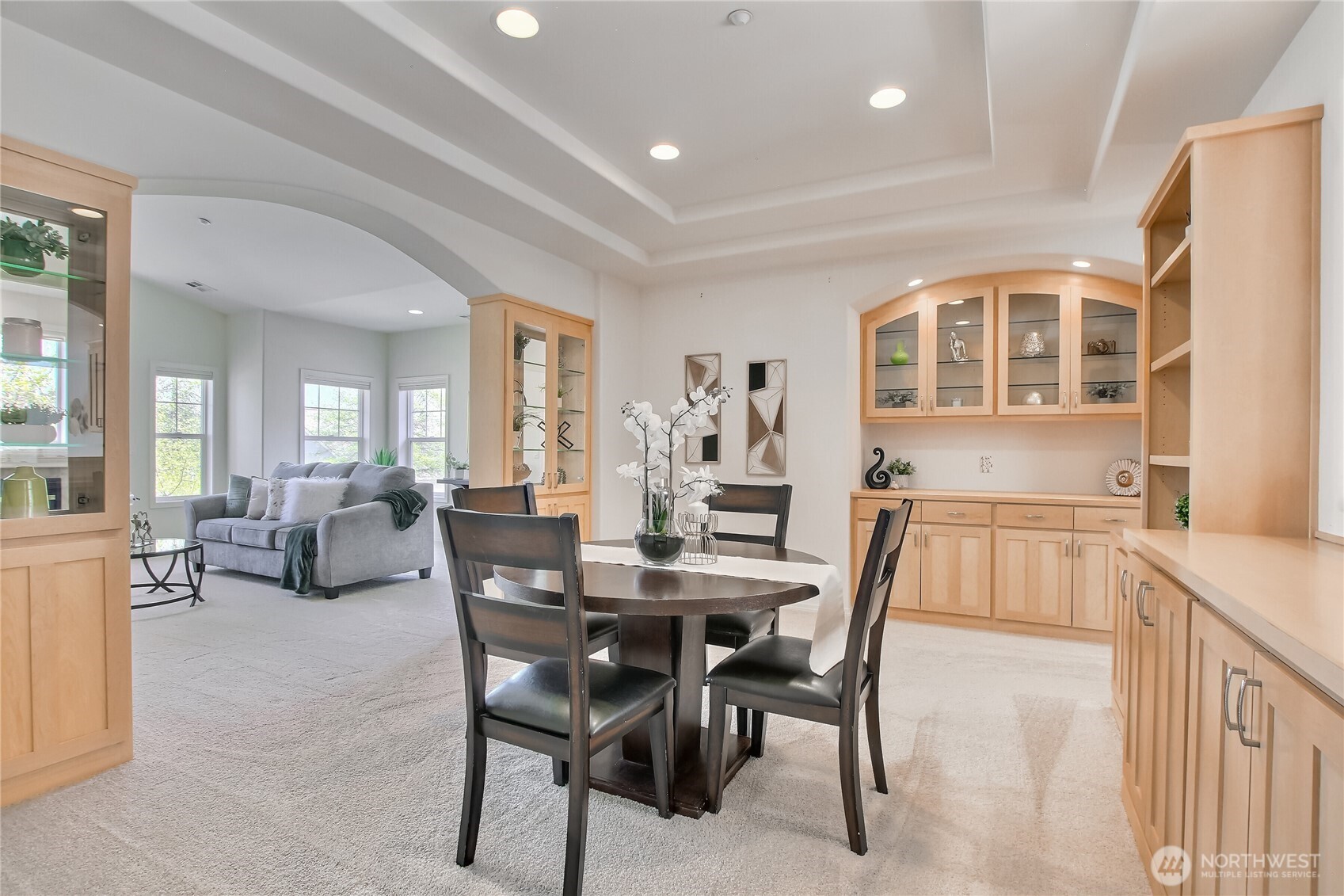 From dining room with coffered ceiling and can lights to the living room with vaulted ceilings.