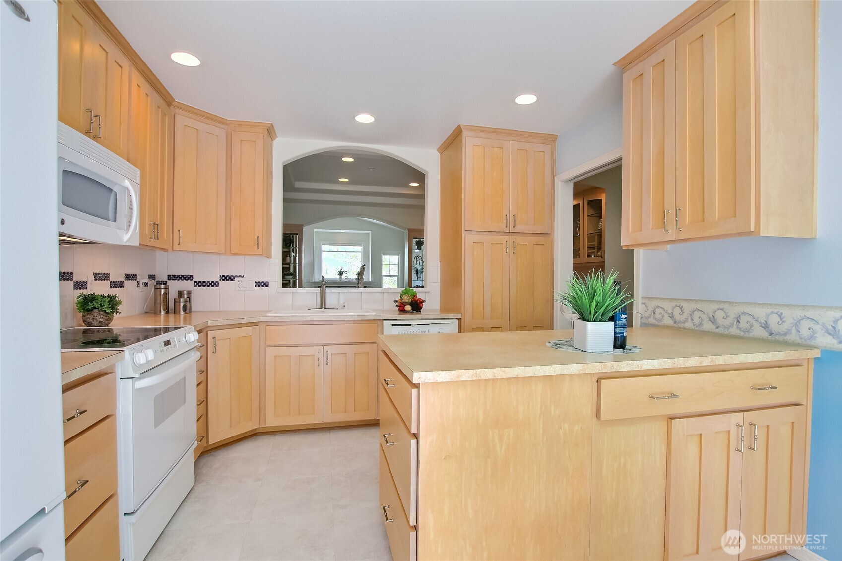 Spacious kitchen with peninsula, eating space, pass through and slider to patio.