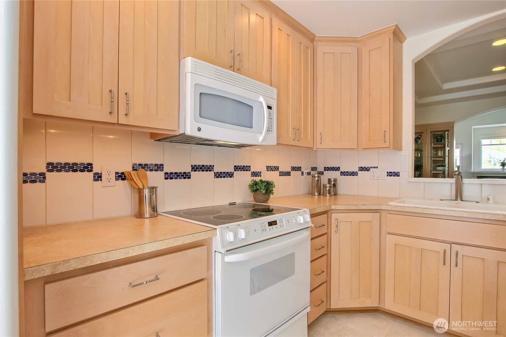 Kitchen features full height cabinets and loads of counter space.