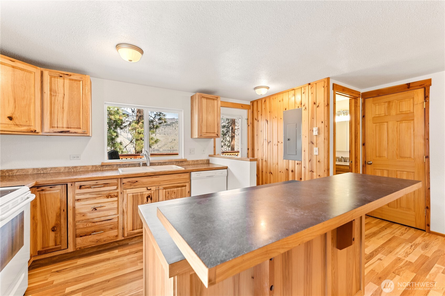 Upper Level Kitchen - View towards powder room and door leading to upper level view deck with outdoor living area.