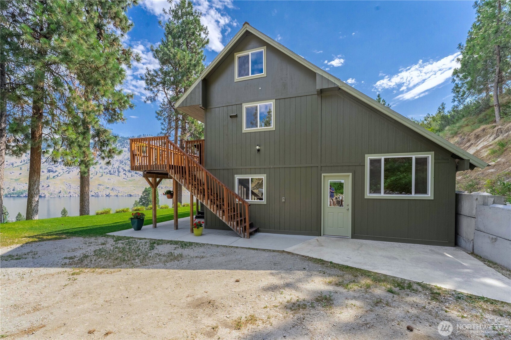 Home entrance w/ spacious parking area and RV parking w/ 30-amp electric service, septic & water hookups.