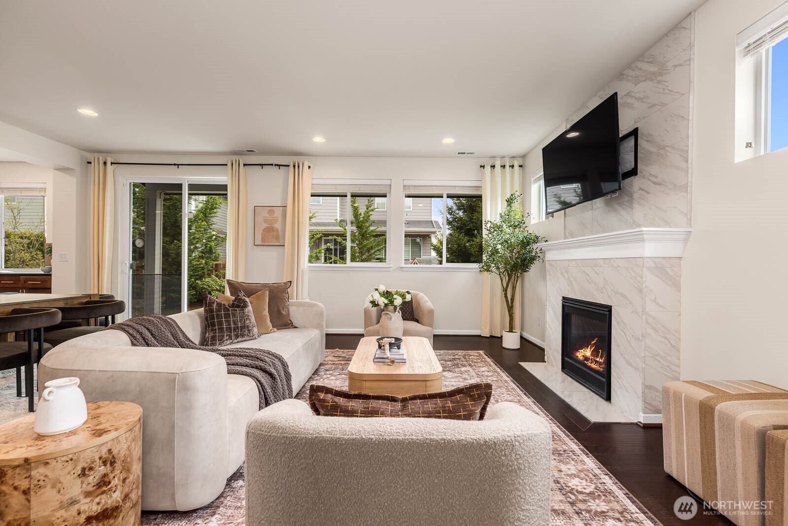 Living room complete with gas fireplace and outdoor back patio access