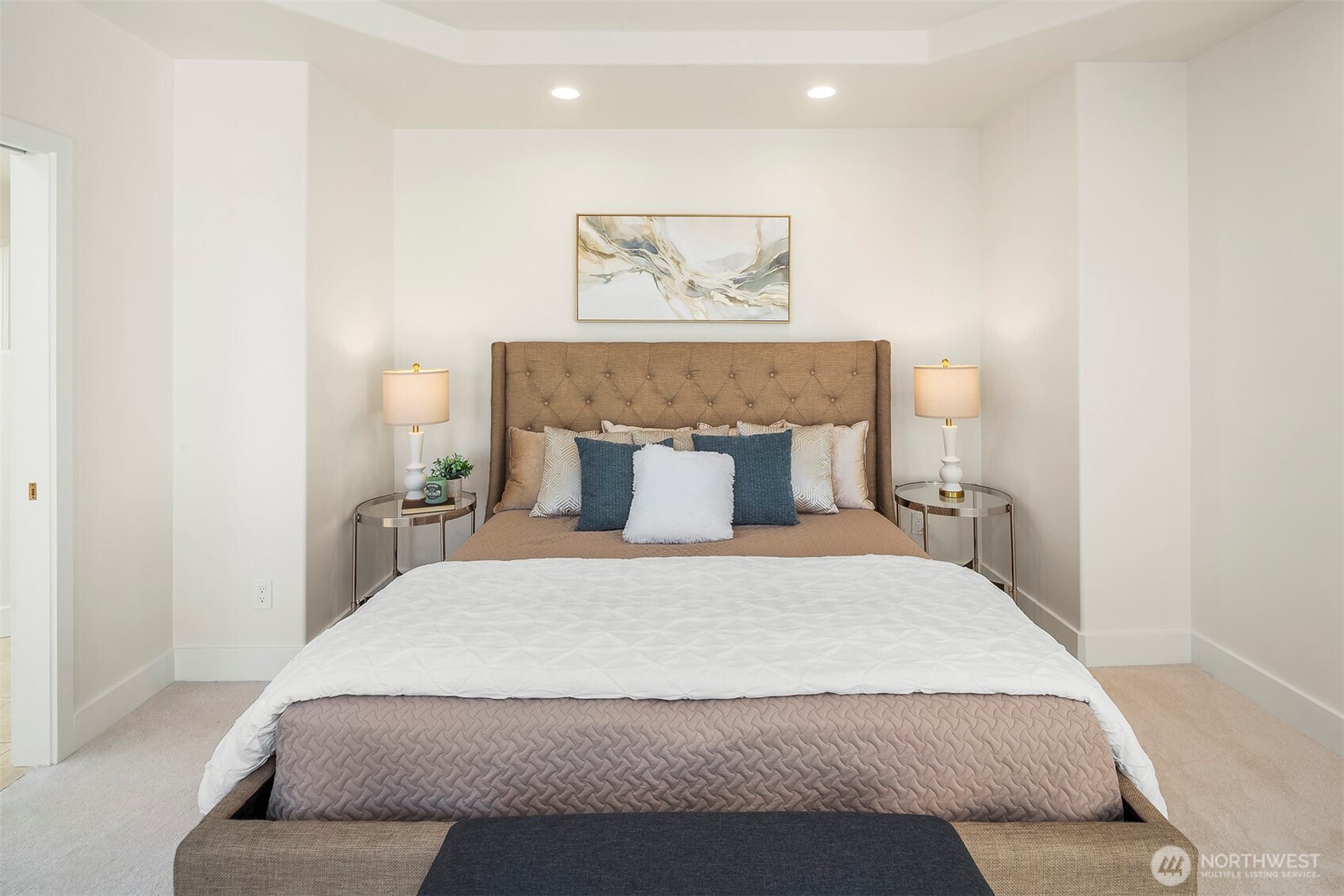 Main-level primary suite with private deck access and panoramic views.