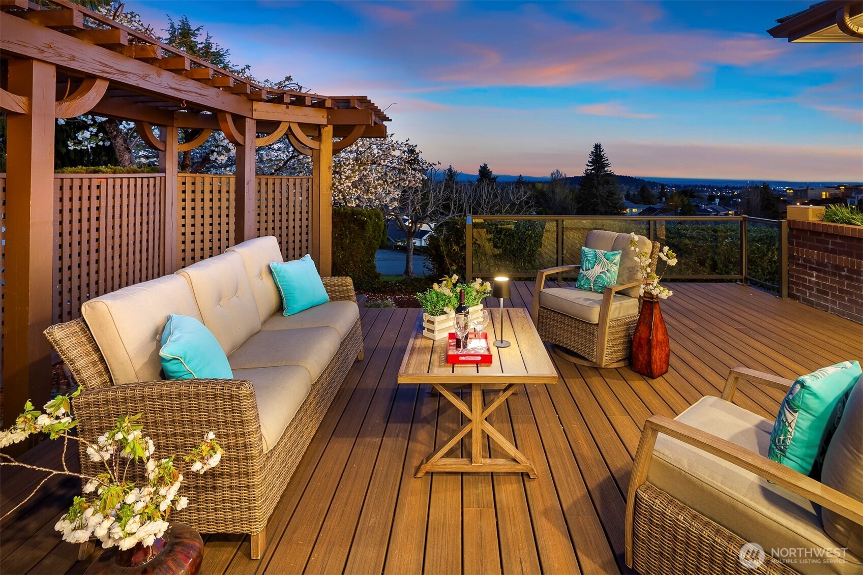 Twilight deck — soft sky glow, distant Mount Rainier silhouette, cool evening breeze, and warm lights as the horizon blushes for lingering conversations.