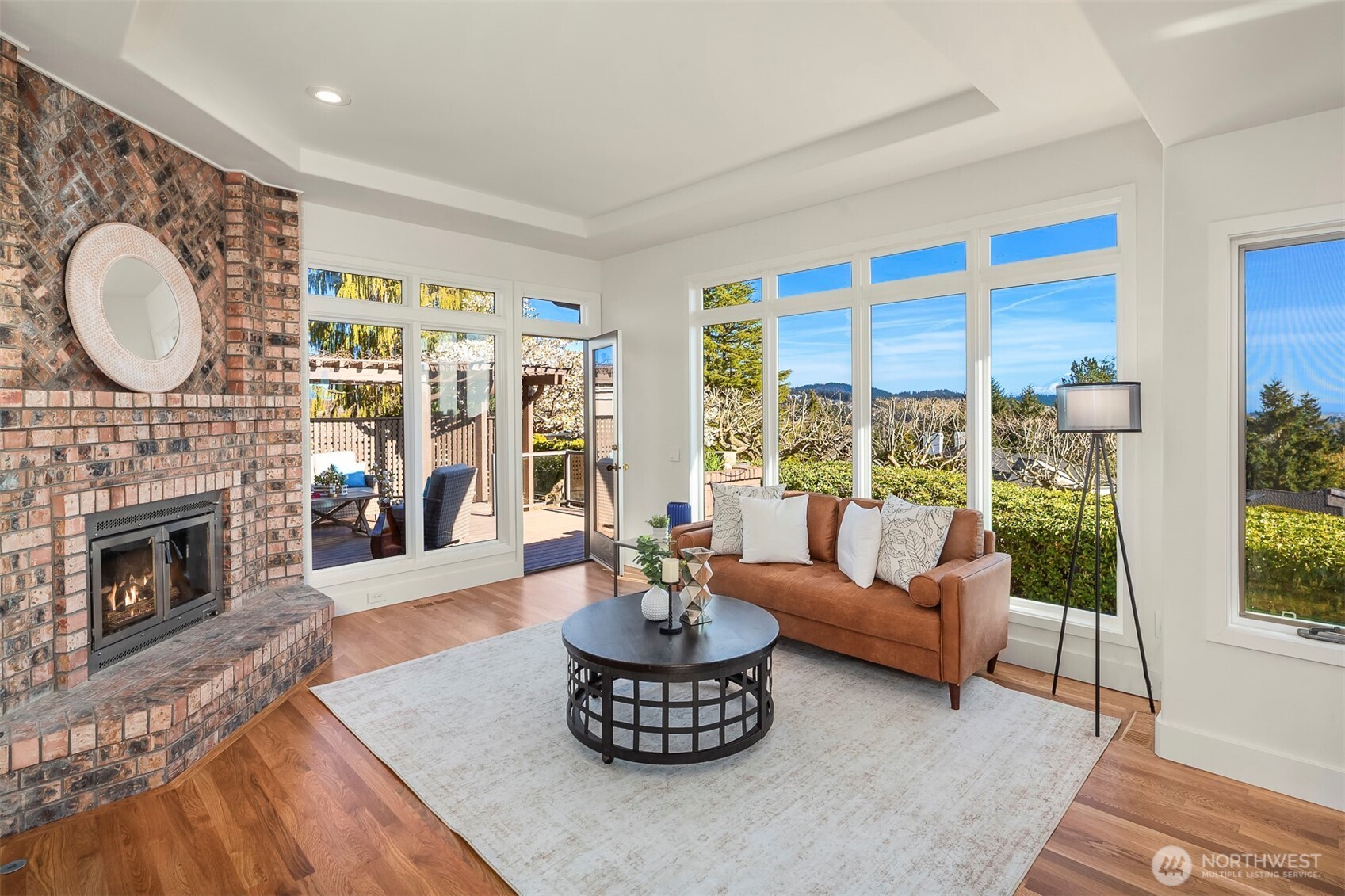 Bright family room or casual living area with new hardwood and fresh paint.