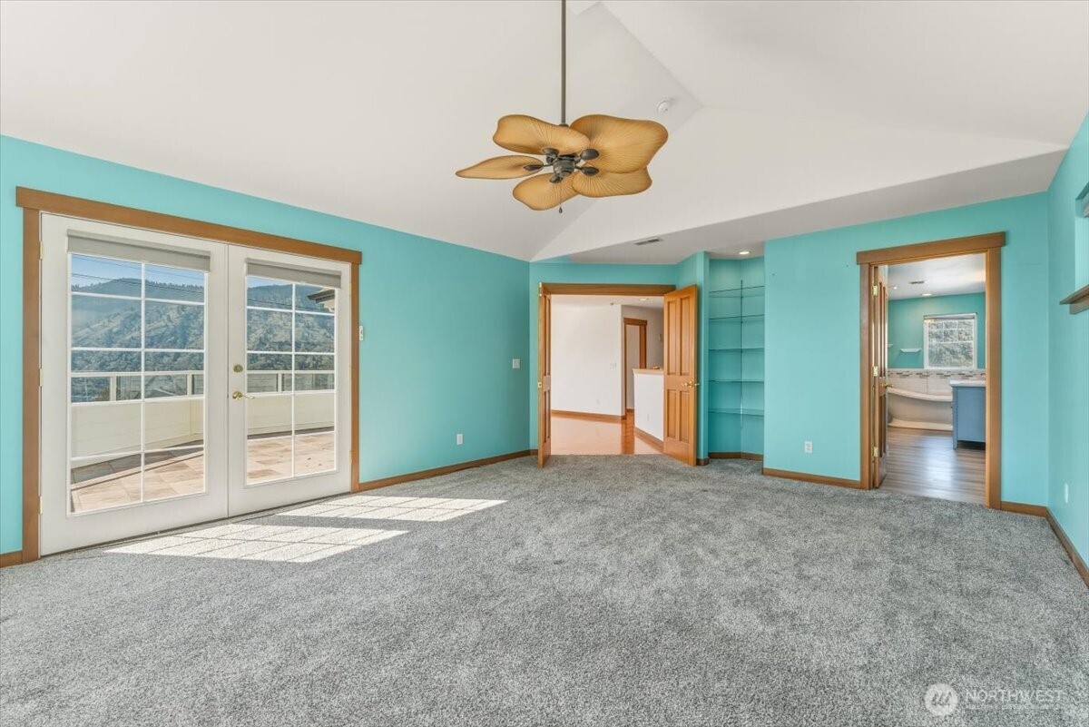 Large primary suite with french doors to the upper view deck