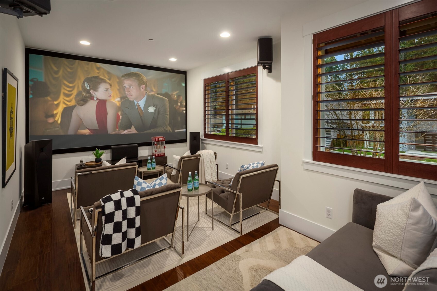 Open media space with projector and large screen—ideal for immersive movie nights.