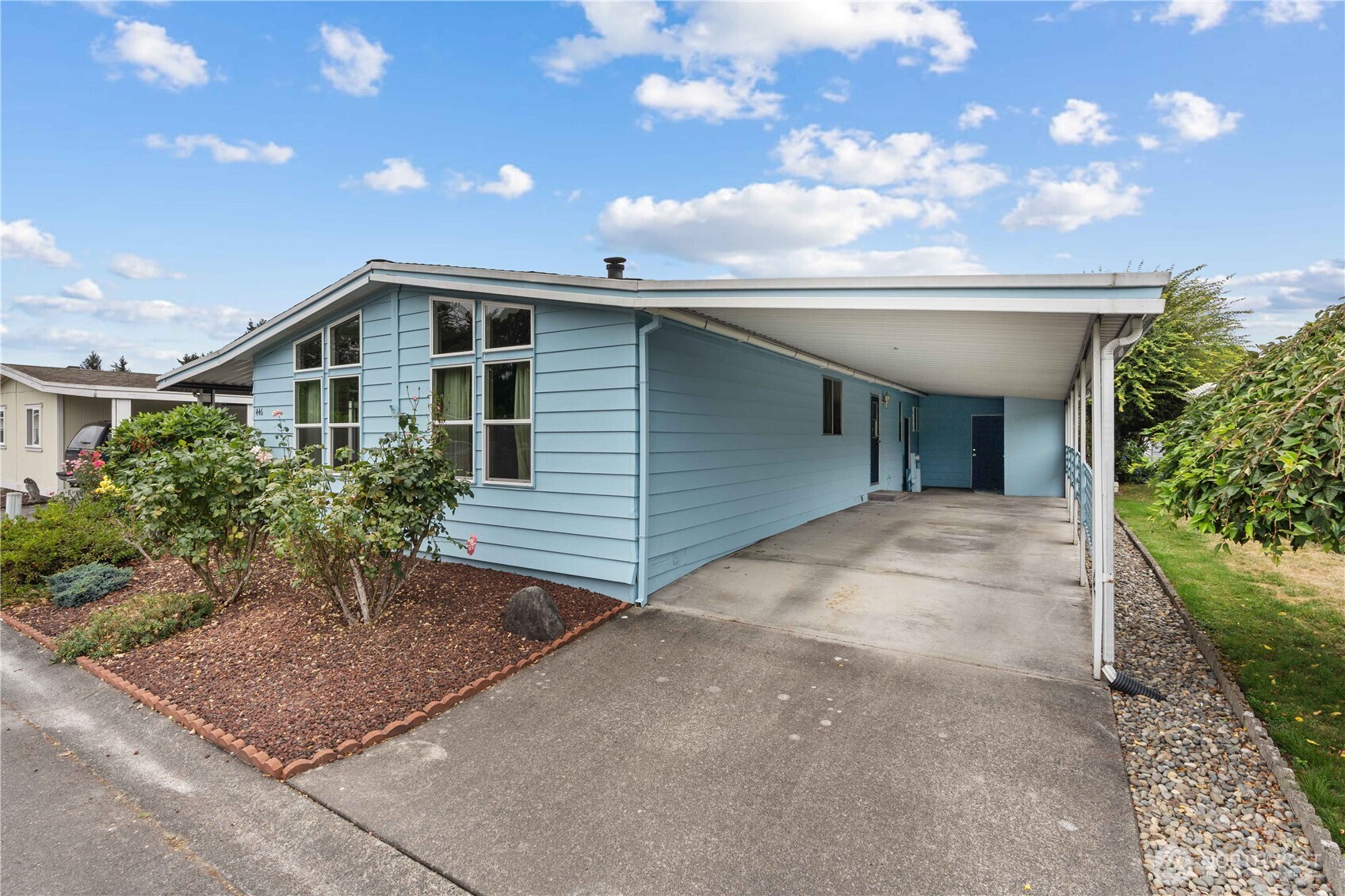 Carport has 2 parking spots and storage units.