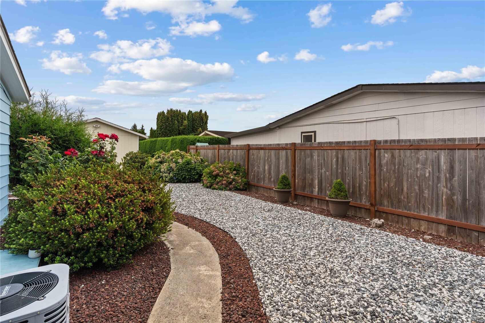 Around the back, there is a private back yard, so easy to maintain and perfect for bbqs. Notice the newer heat pump for A/C on those hot days!