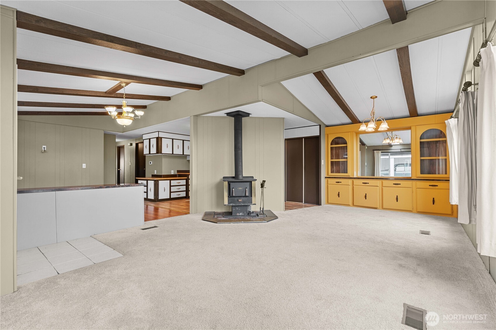 Another angle of large living/dining great room area with vaulted ceilings and open floorplan.