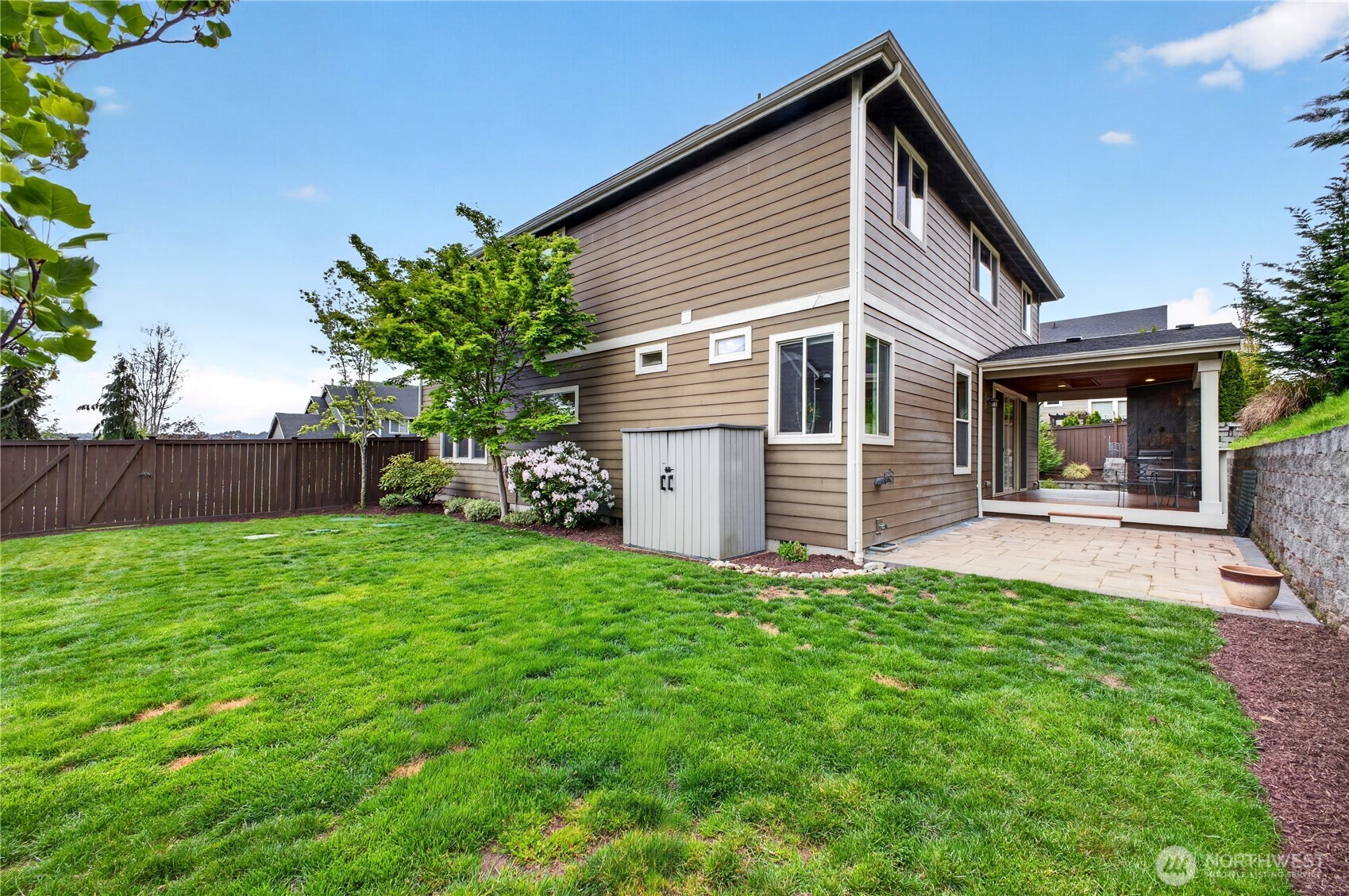 Fully fenced and landscaped quarter-acre lot includes a sprinkler system & small shed, providing both privacy and easy maintenance for year-round enjoyment.