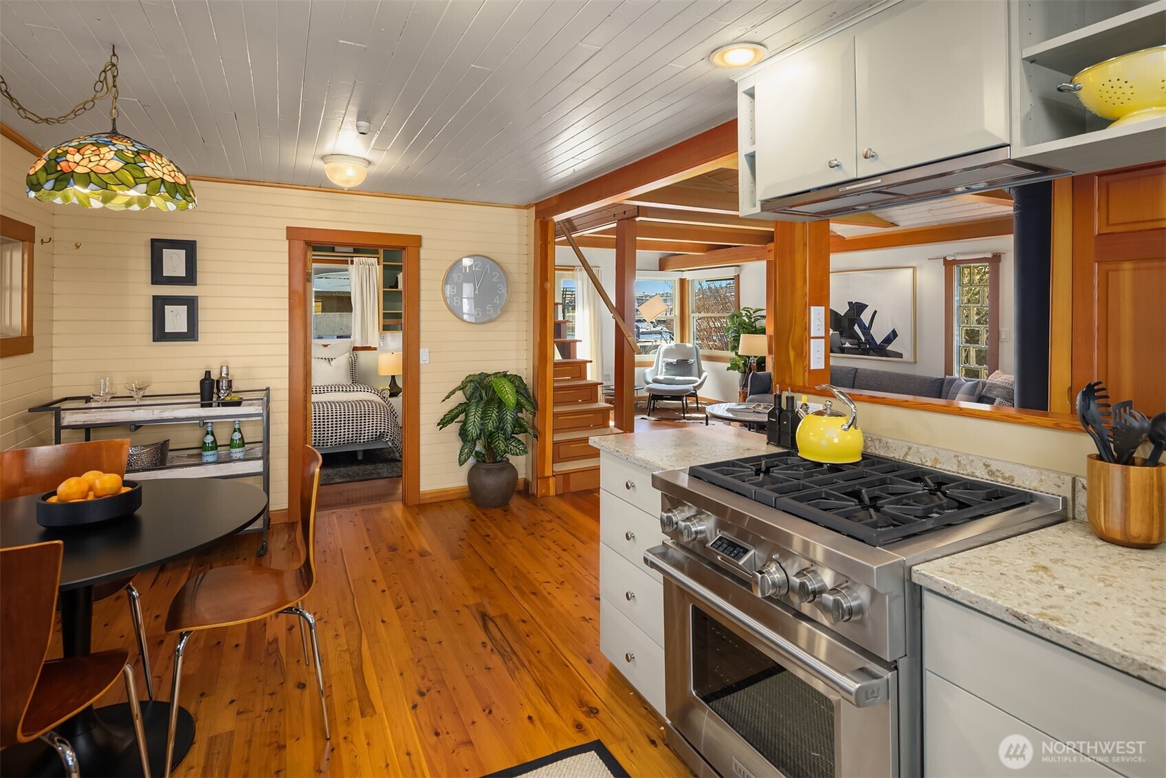 The open sightlines from kitchen to living room to bedroom give the home a surprisingly spacious feel, with warm hardwood floors tying every space together.