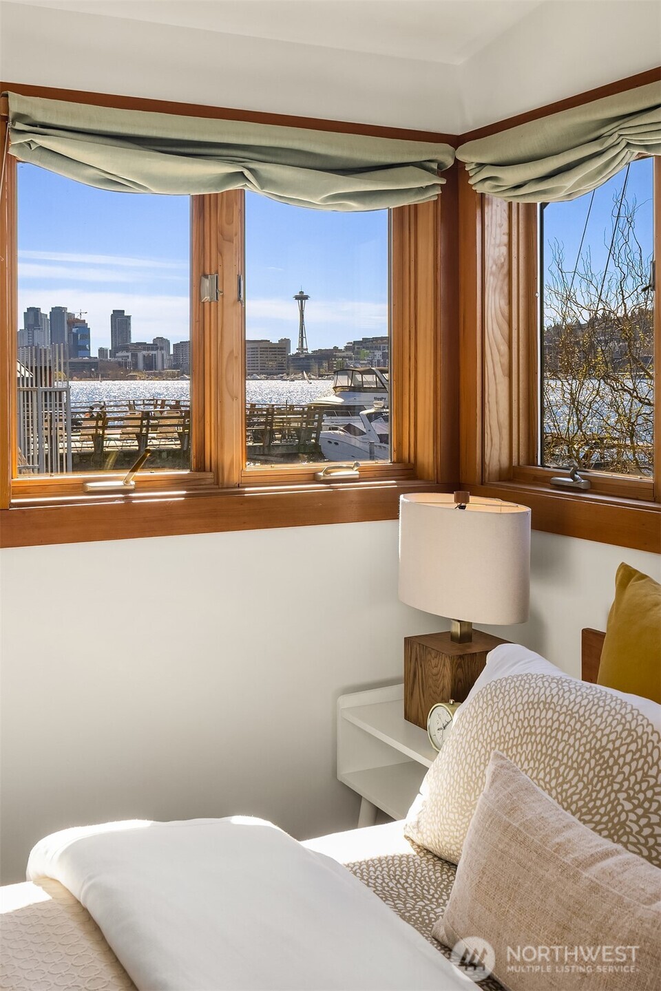 Wake up to this. The Space Needle and Seattle skyline fill the corner windows of the primary bedroom, a view that never gets old.