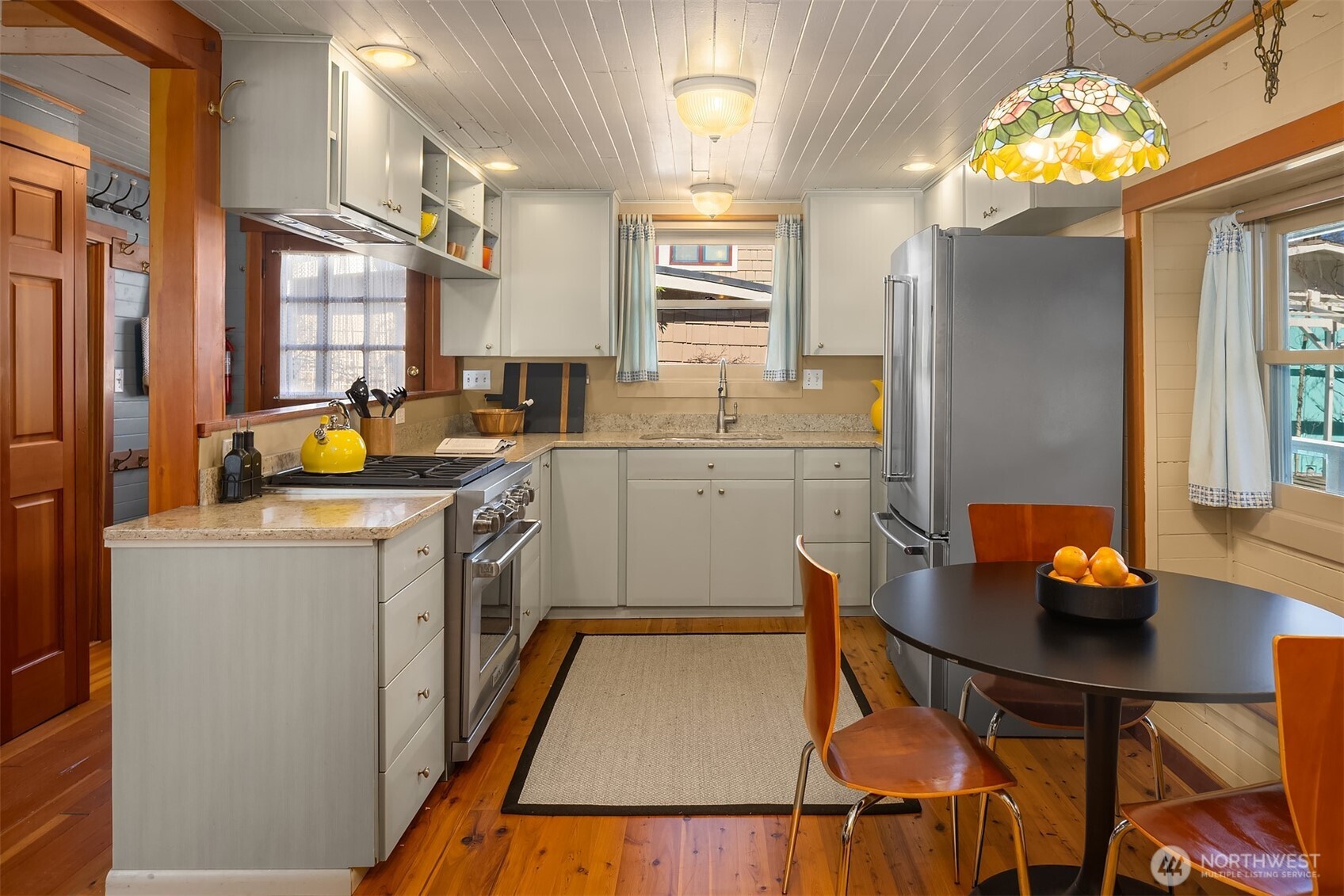 A professional gas range and thoughtfully designed cabinetry make this kitchen a genuine cook's space, with the dining nook just steps away for easy entertaining.