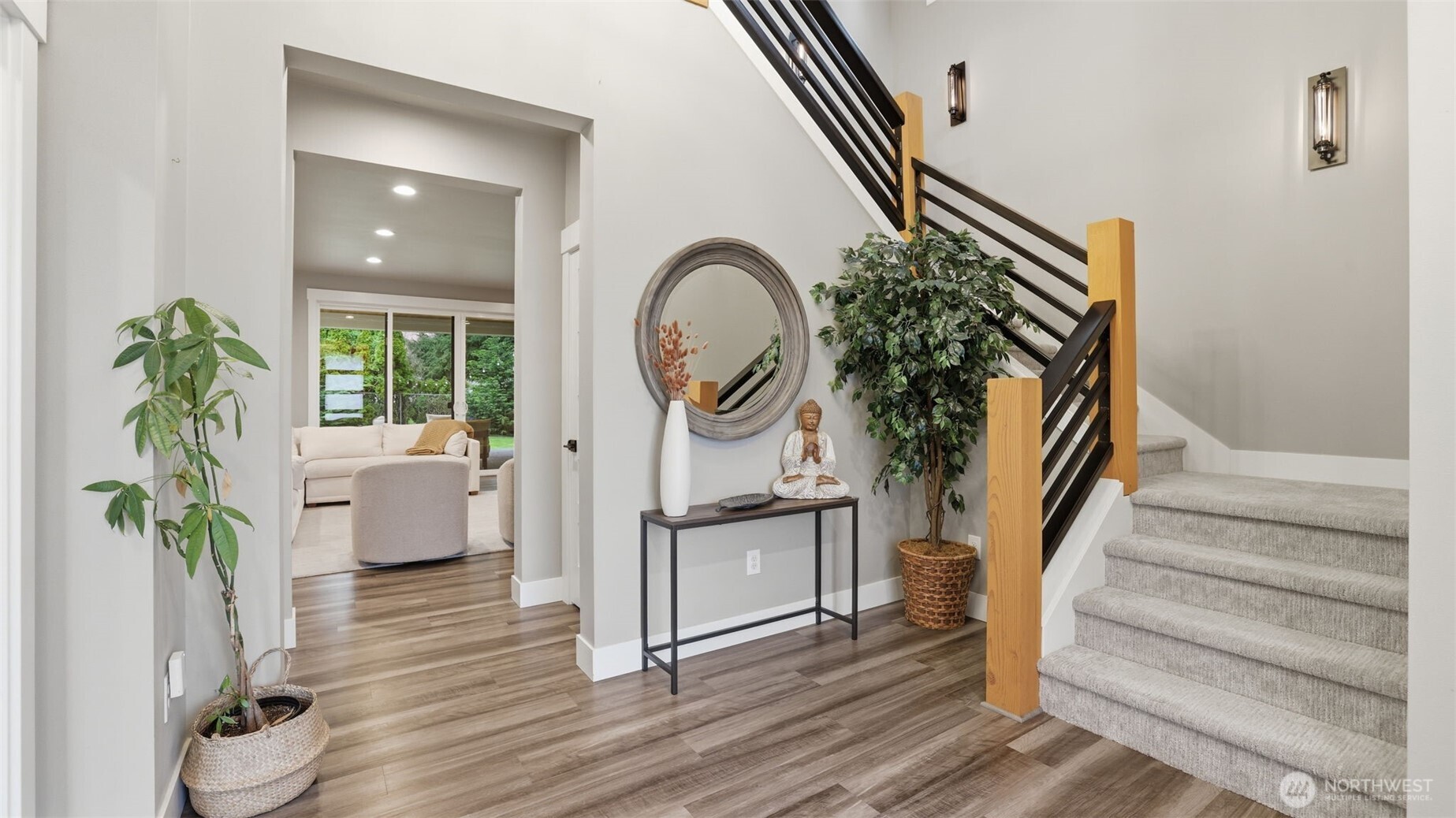 Enter to the den (or main floor bedroom) on the left and the stairs to your right. Additional features include LVP flooring, quartz surfaces throughout, tankless water heater, and gas furnace with heat pump.