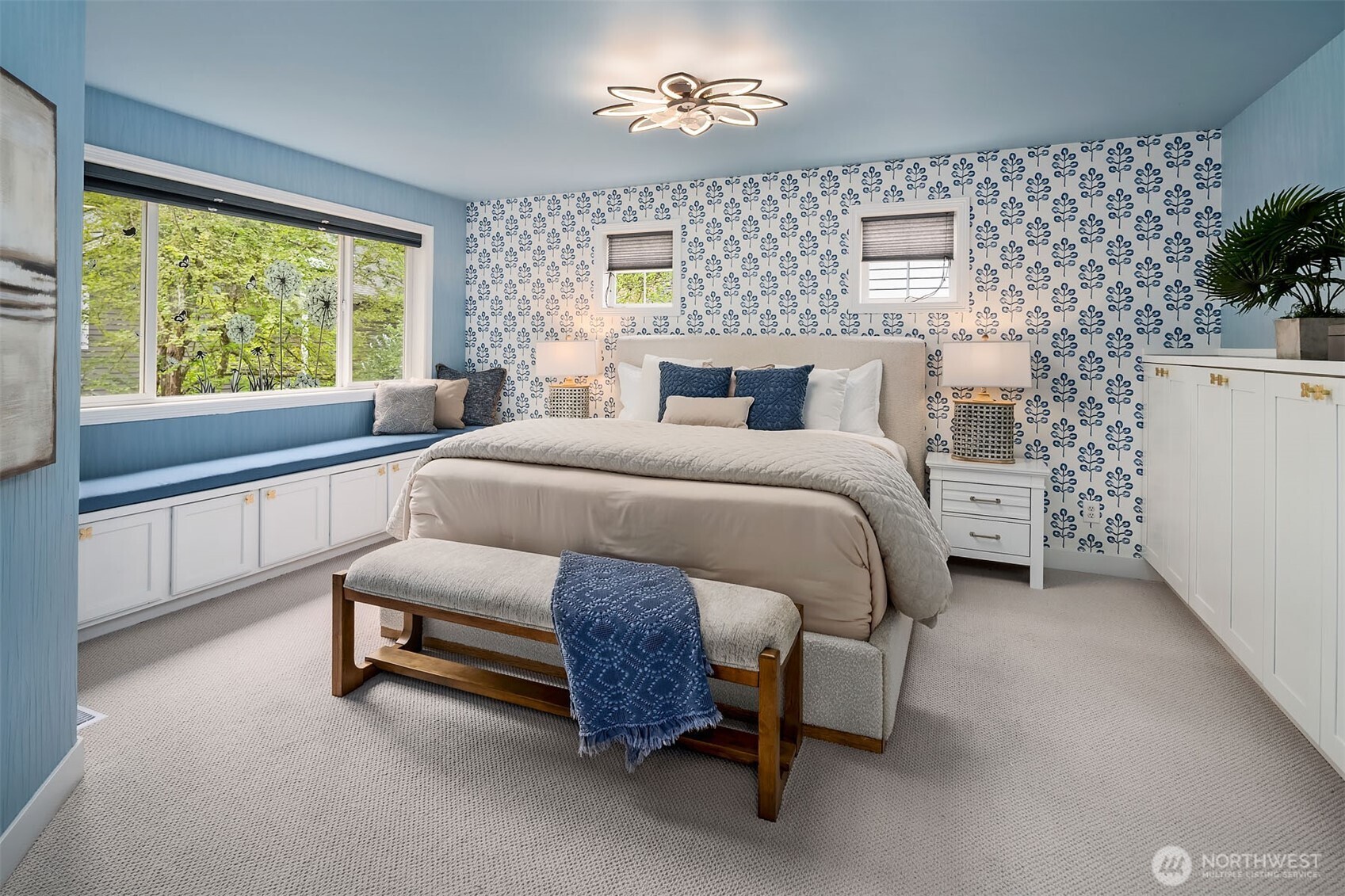 Primary bedroom with window seat and custom built-ins.
