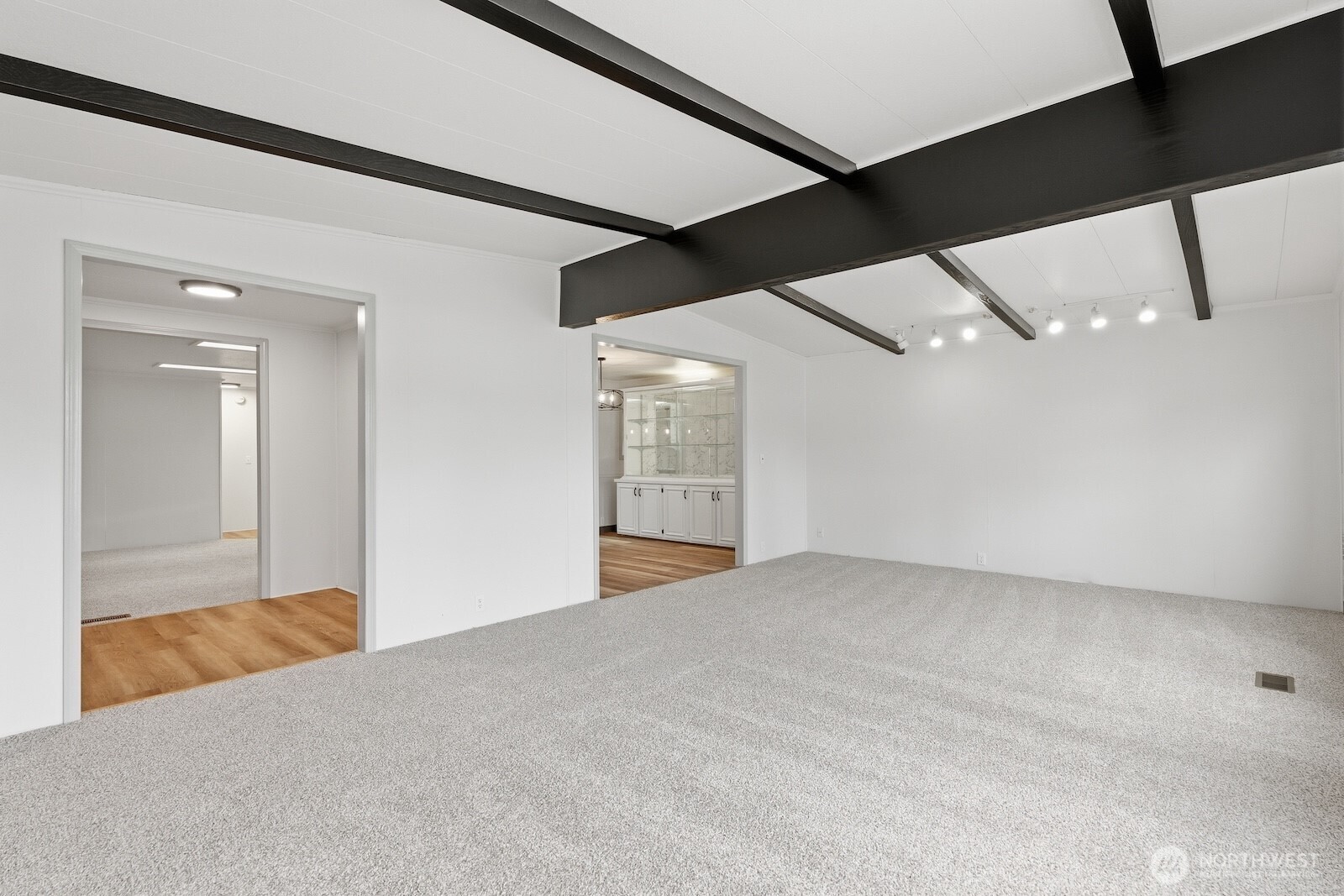 Large family room with lots of natural light and vaulted ceilings