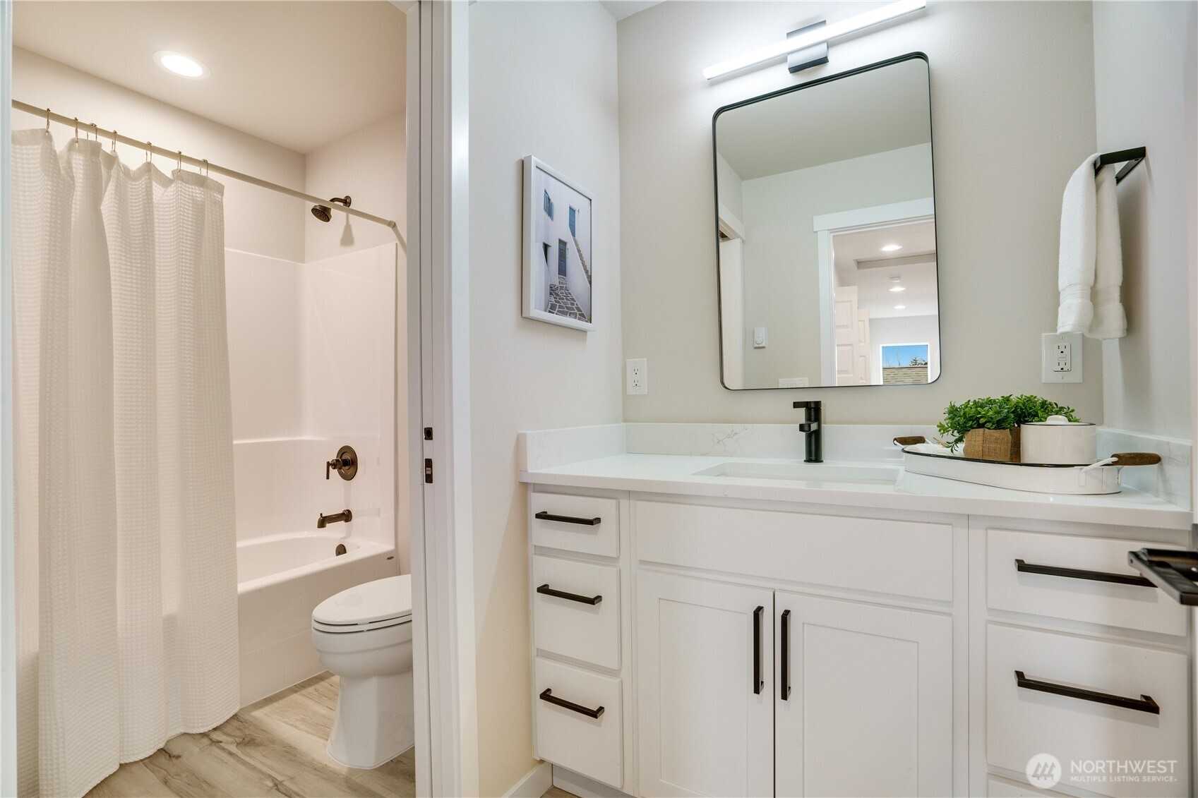 The hall bathroom has a soaking tub and custom lighting, too.