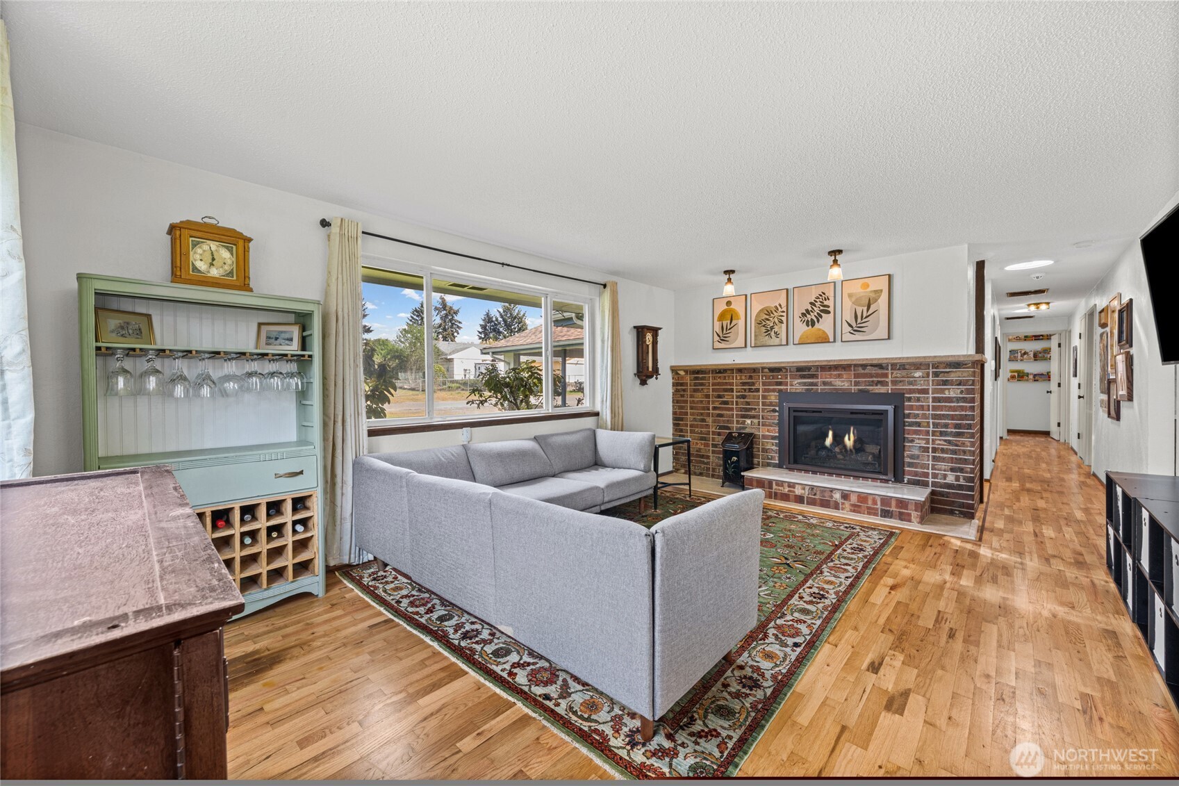 Another view of the spacious living area.  The hallway on the right goes to a primary bedroom with en-suite and two additional bedrooms.