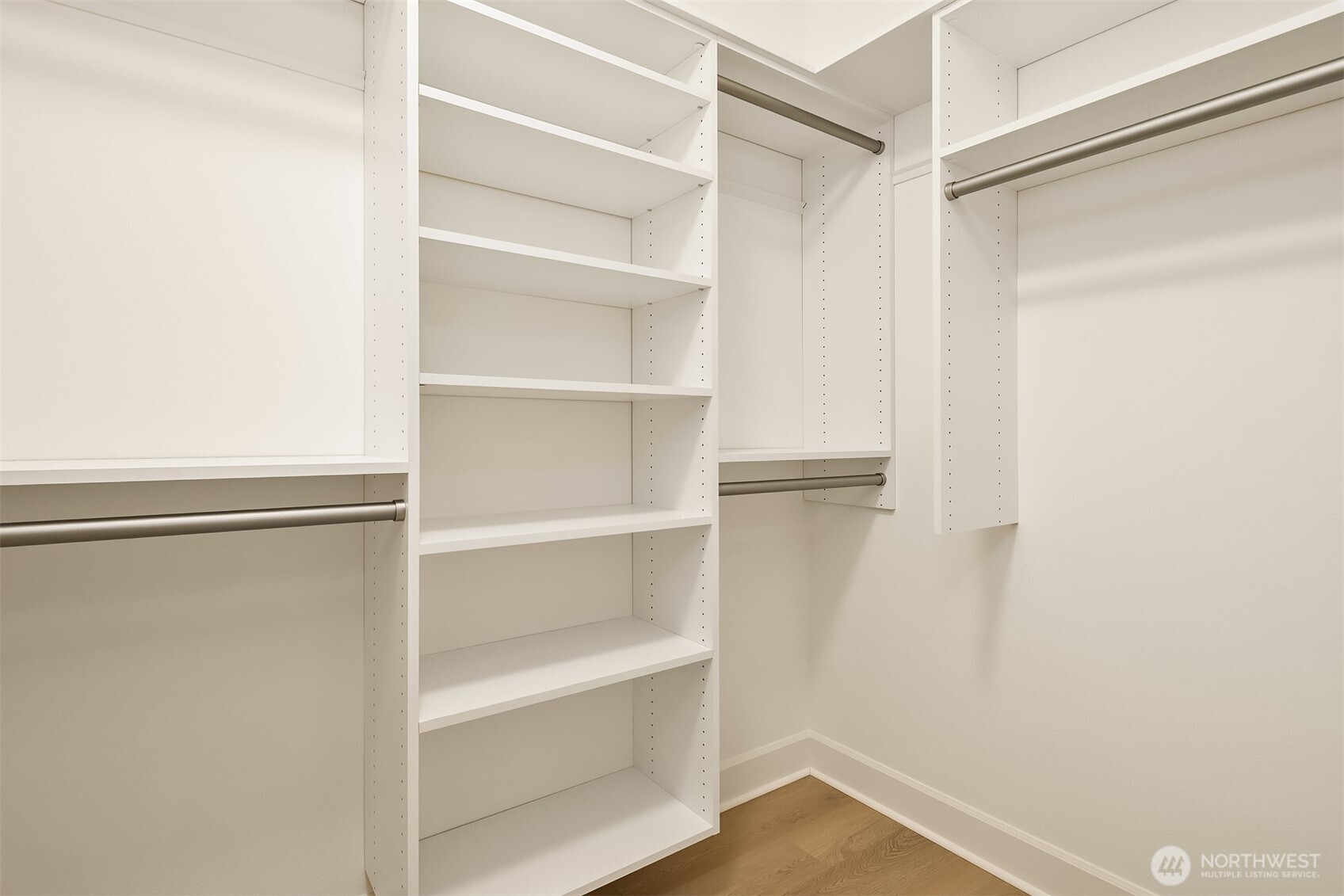 Custom built in shelving in primary closet with adjustable shelves