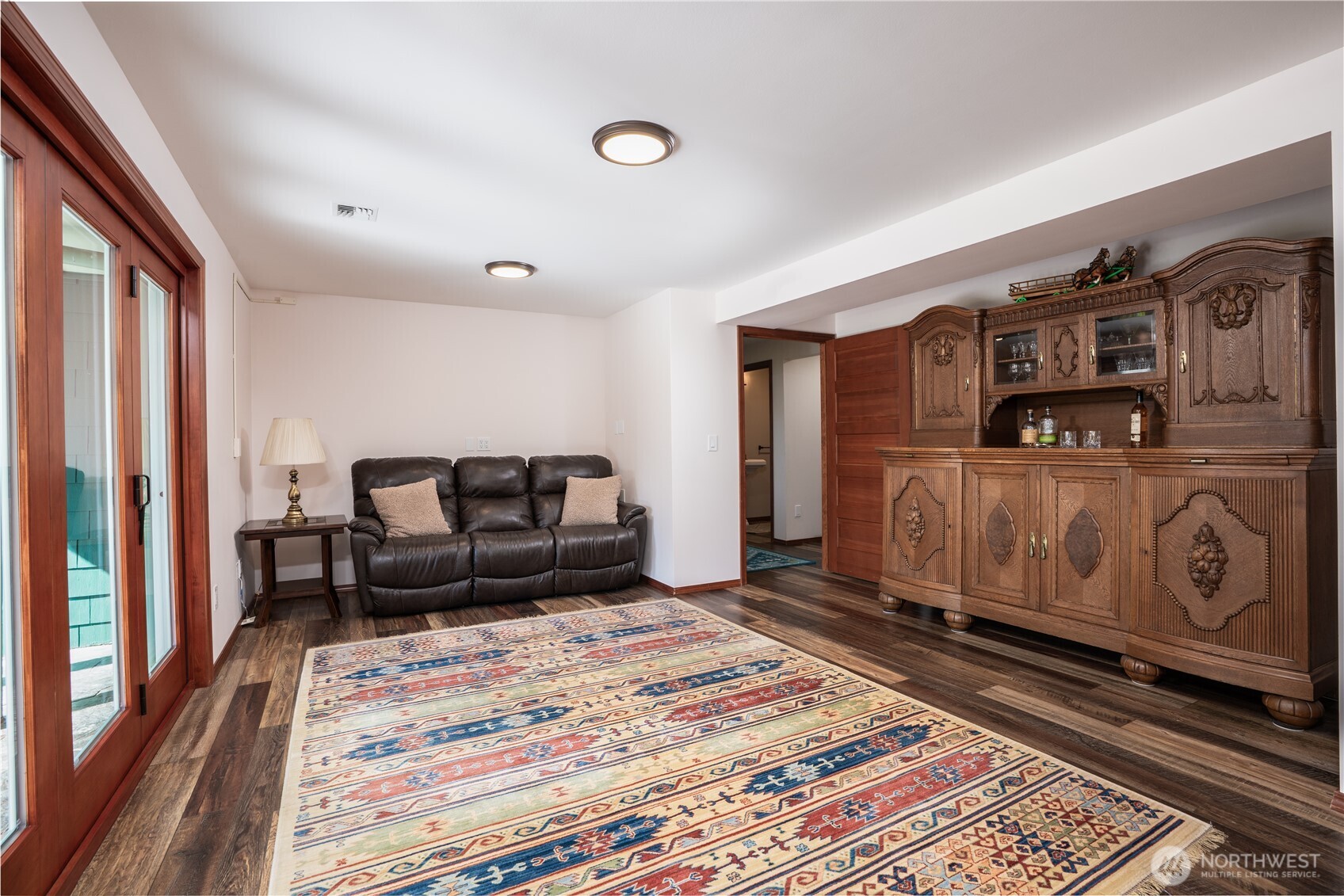 Lower level family room leading to outdoor terrace and hot tub.