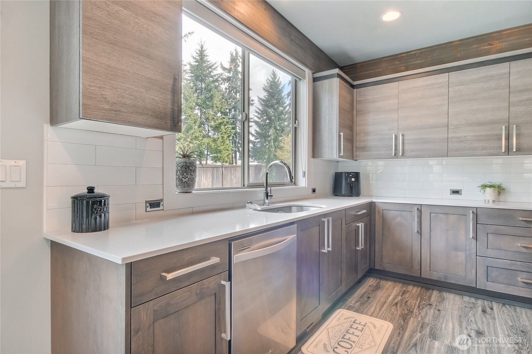 Beautiful Chefs kitchen has stylish two tone cabinets with tile backsplash.
