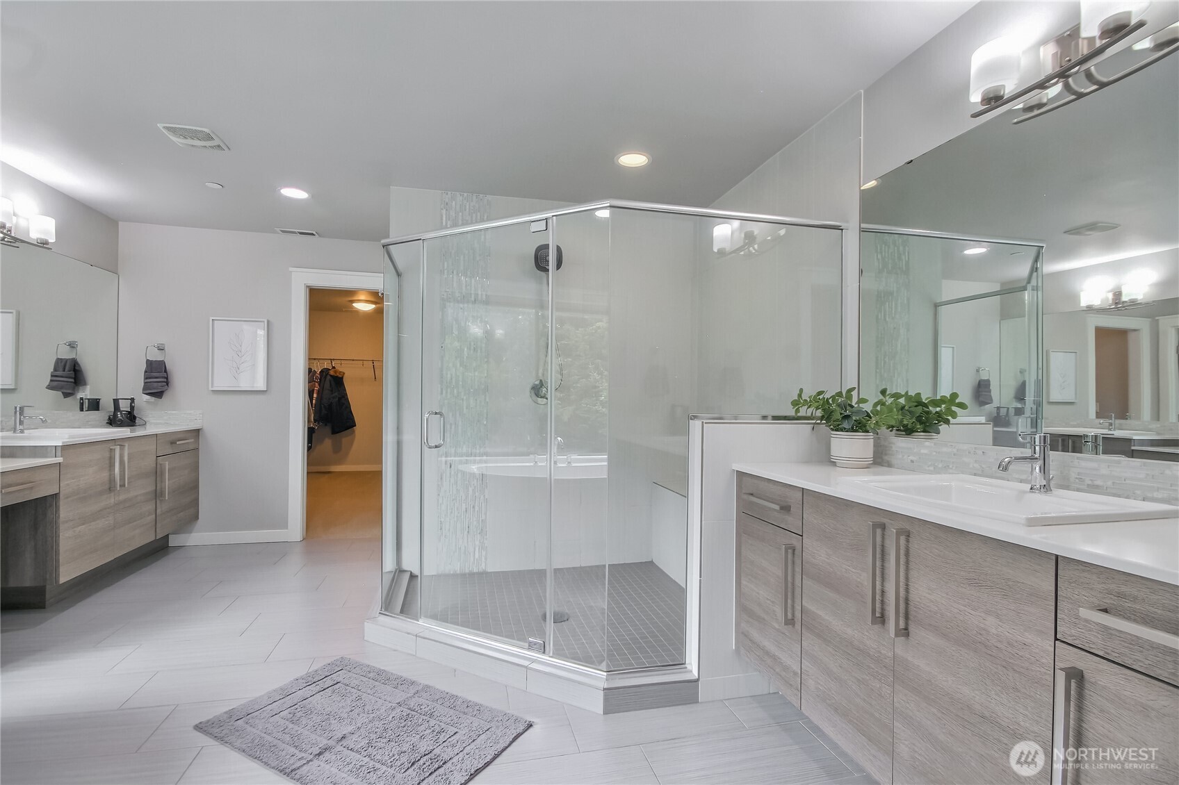 Massive primary bedroom with valuted ceiling and recessed lighting.