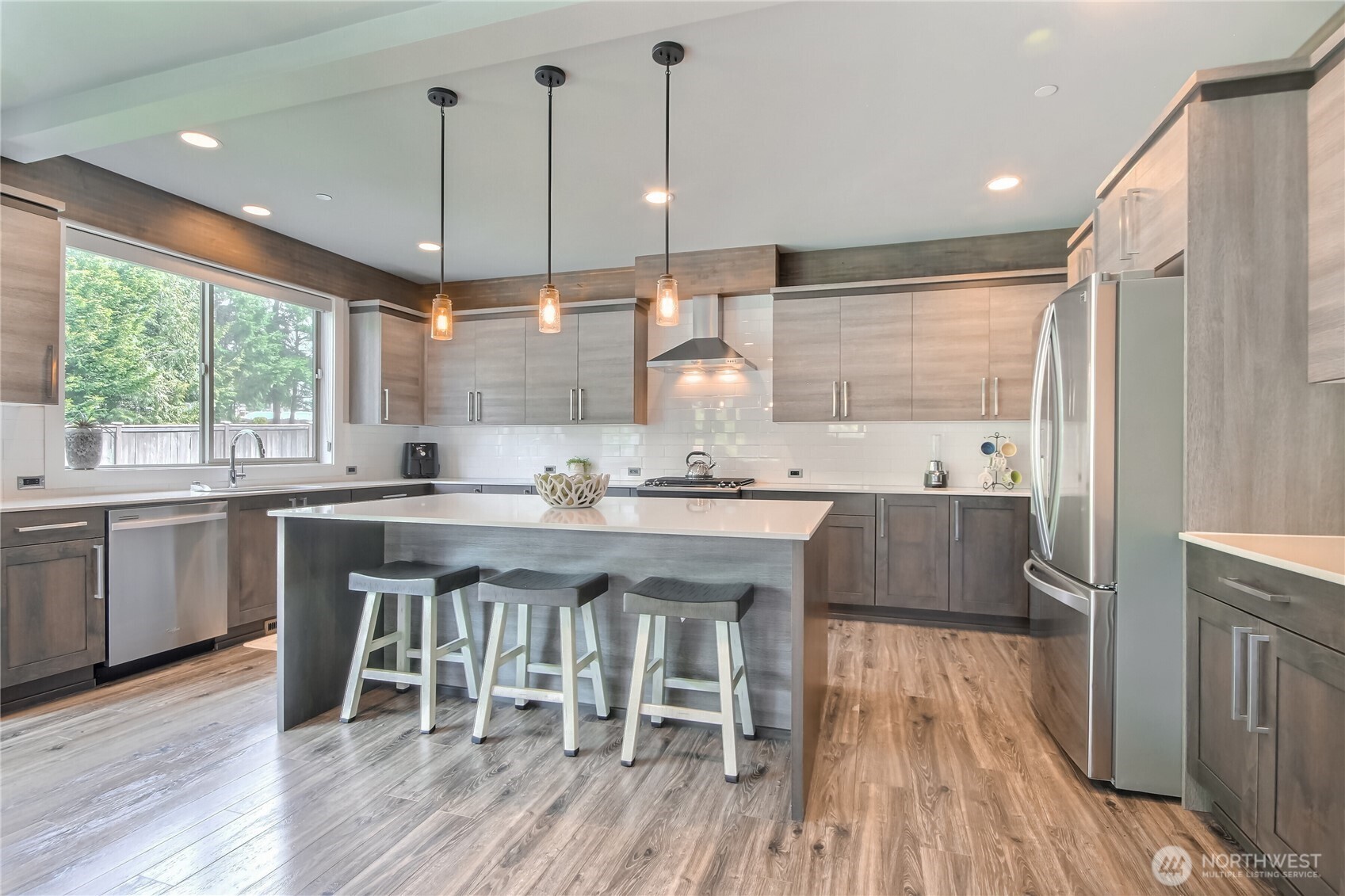 Stunning chef kitchen features rich two-tone cabinetry for depth & contrast. Tons of counter space and cabinets for all kitchen supplies.