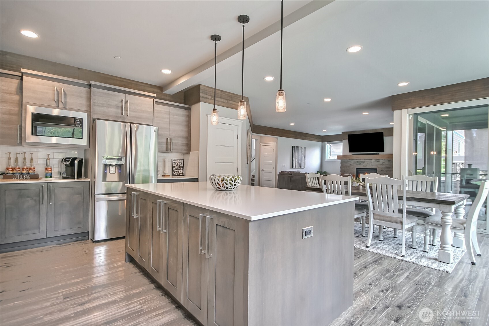 An oversized quartz island serves as a stunning centerpiece, offering seating for dining & effortless entertaining.