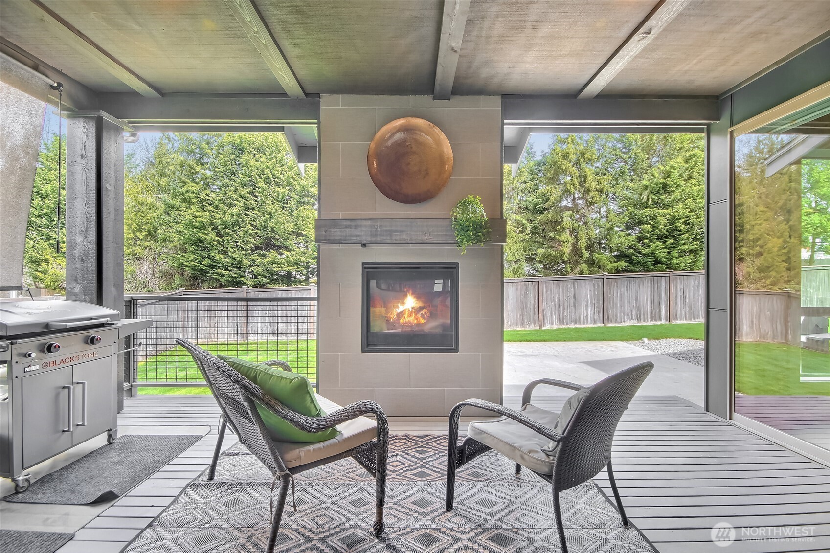 Outdoor covered deck with gas fireplace.