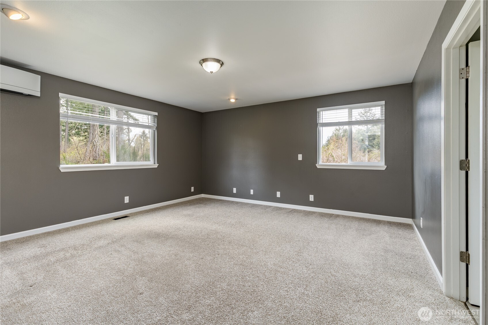 Expansive main-floor primary suite serves as a private retreat, complete with its own dedicated mini-split system for personalized comfort