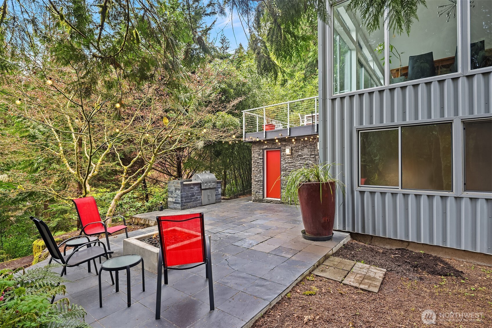 Outdoor fireplace creates a warm gathering spot.