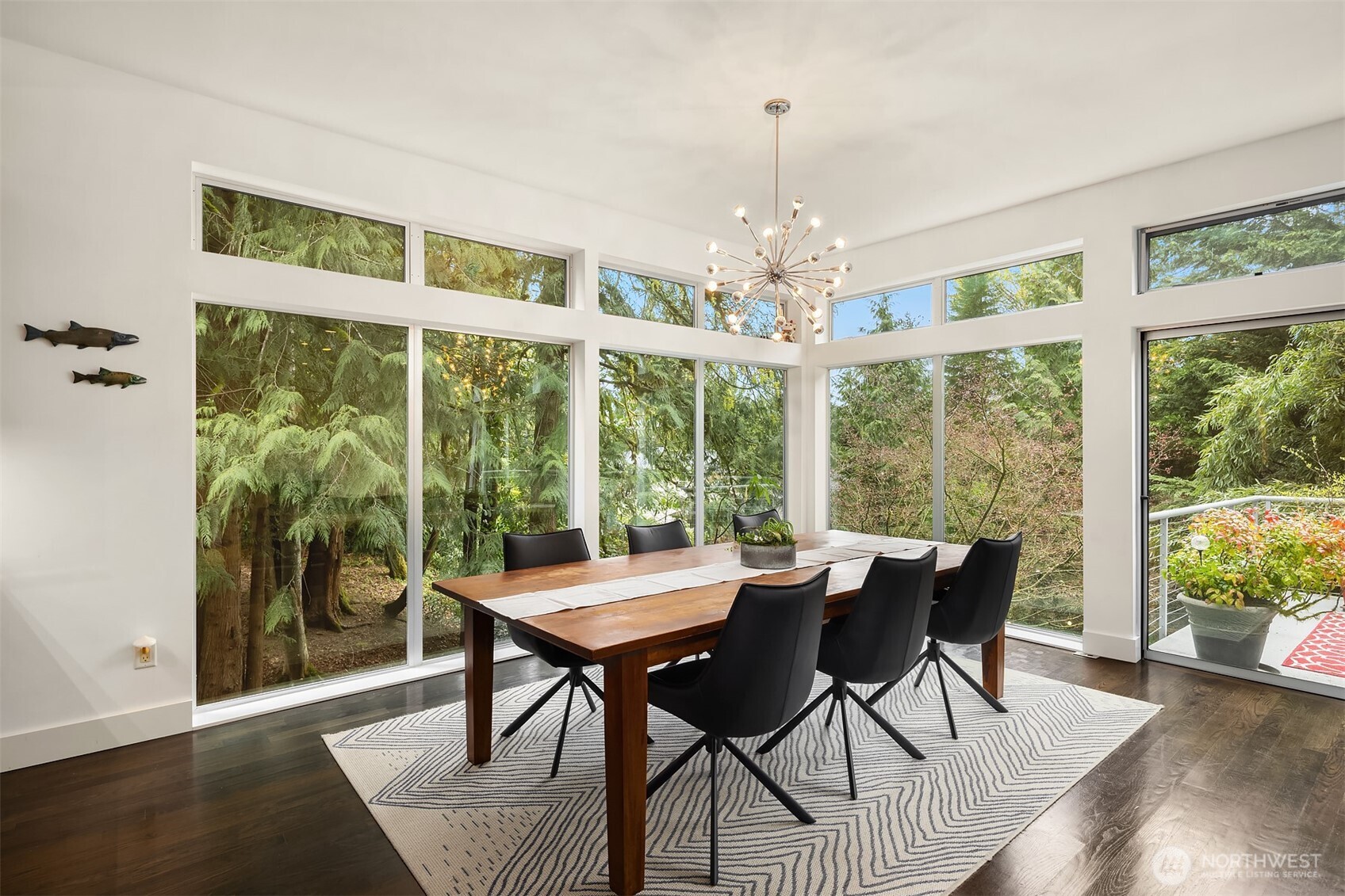 Dining area framed by windows and natural views.