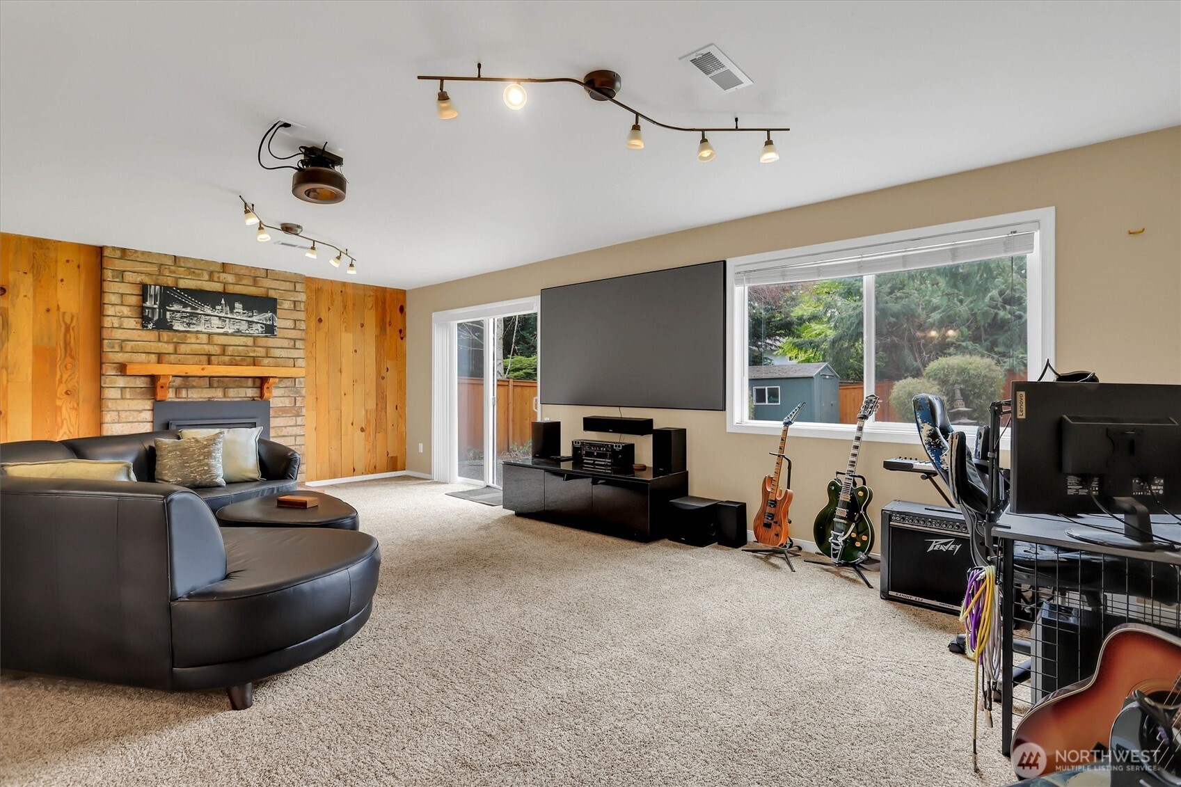 Family room in the basement is a wonderful entertainment space.  Built in theater stays.   Sliding door to back yard patio.