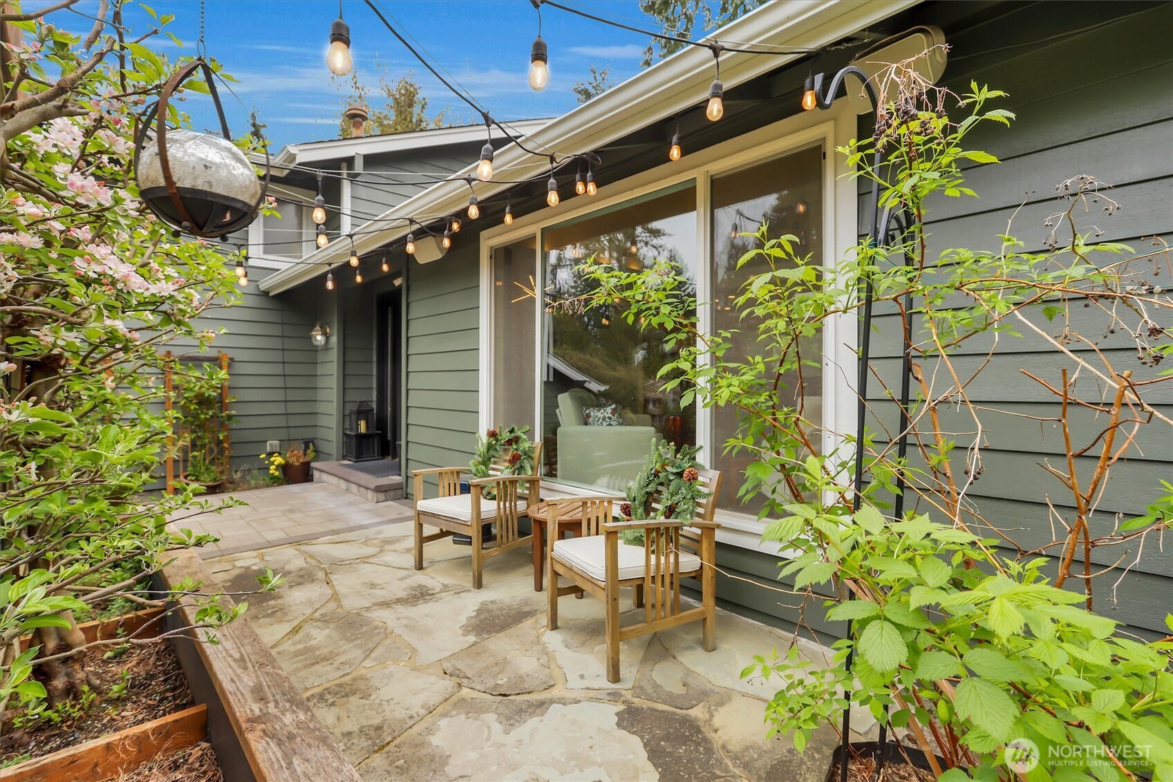 Stone front patio-sitting area with apple tree.