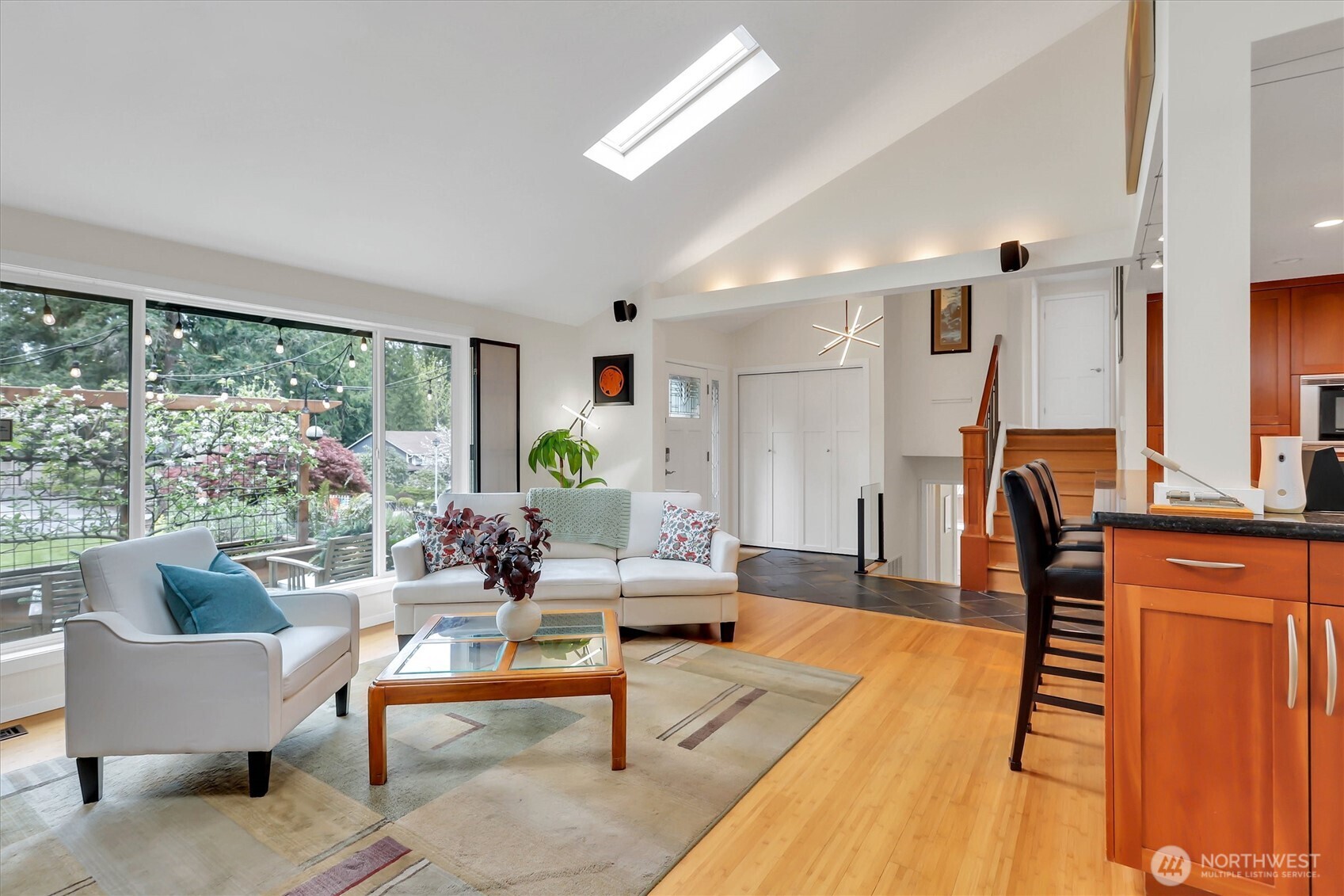 Vaulted ceilings with skylights, floor to ceiling windows and extra lighting makes a cheerful home.