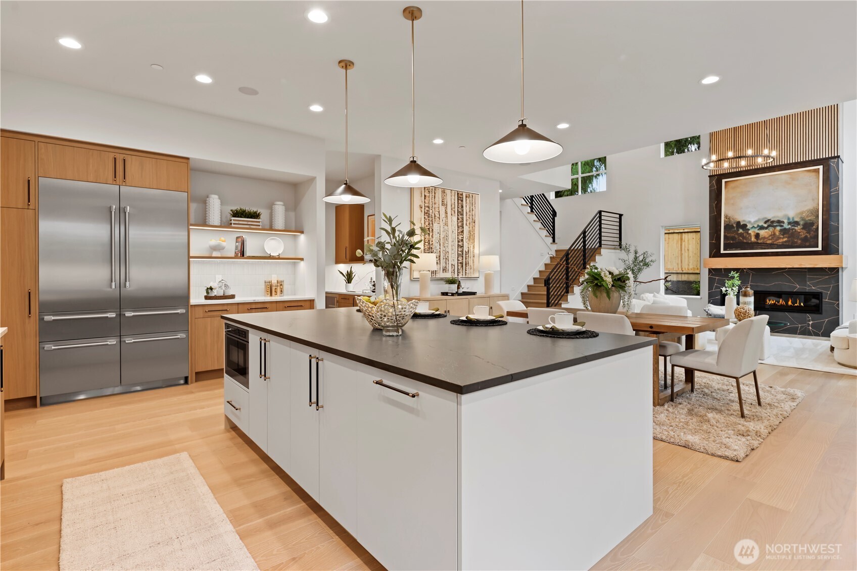 Expansive island with seating for four, pendant iights plus LED accents.