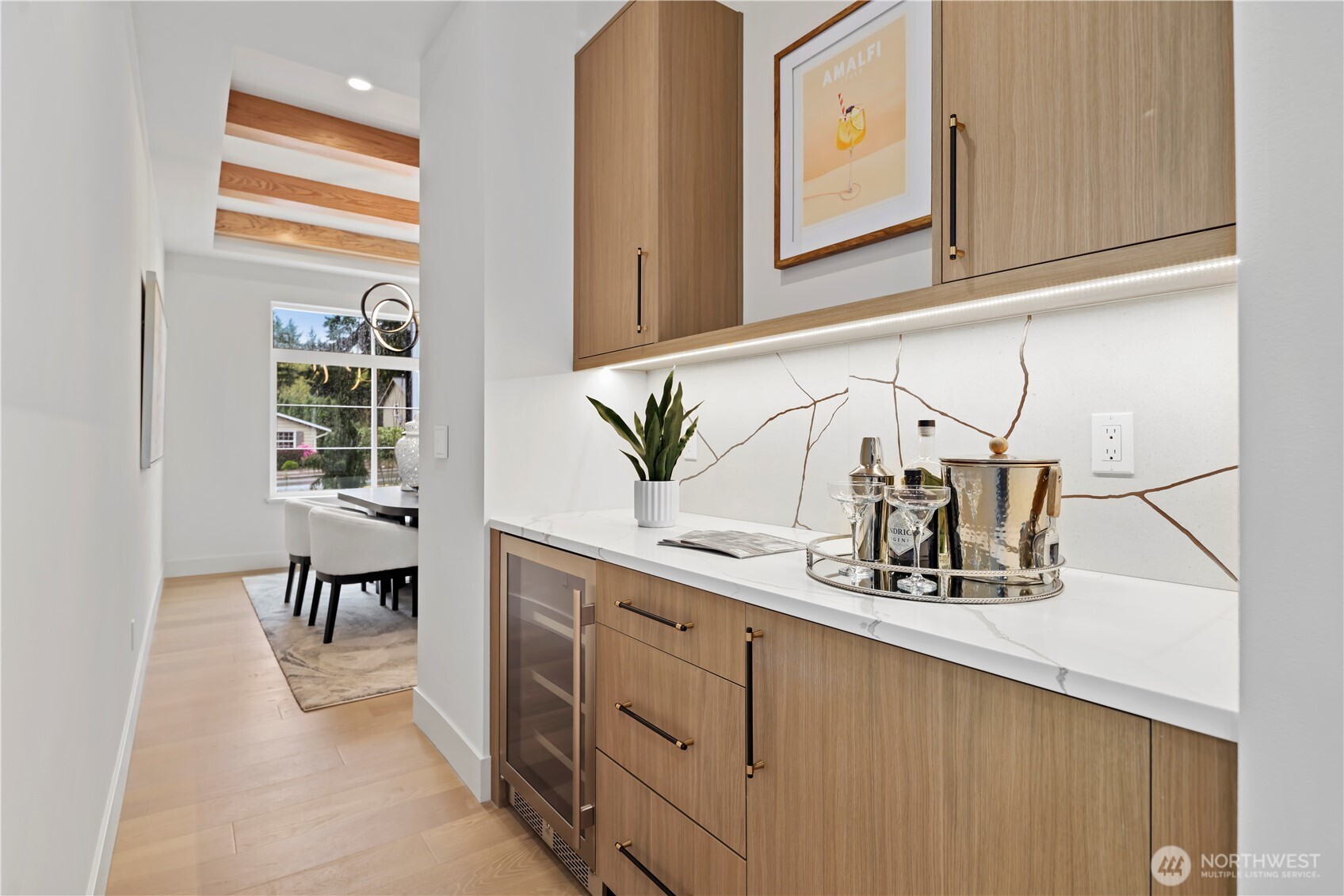 Thermador range with custom-framed hood. 6-burner, griddle, double ovens, and Wi-Fi enabled. Single-basin stainless steel sink with pull-out sprayer.