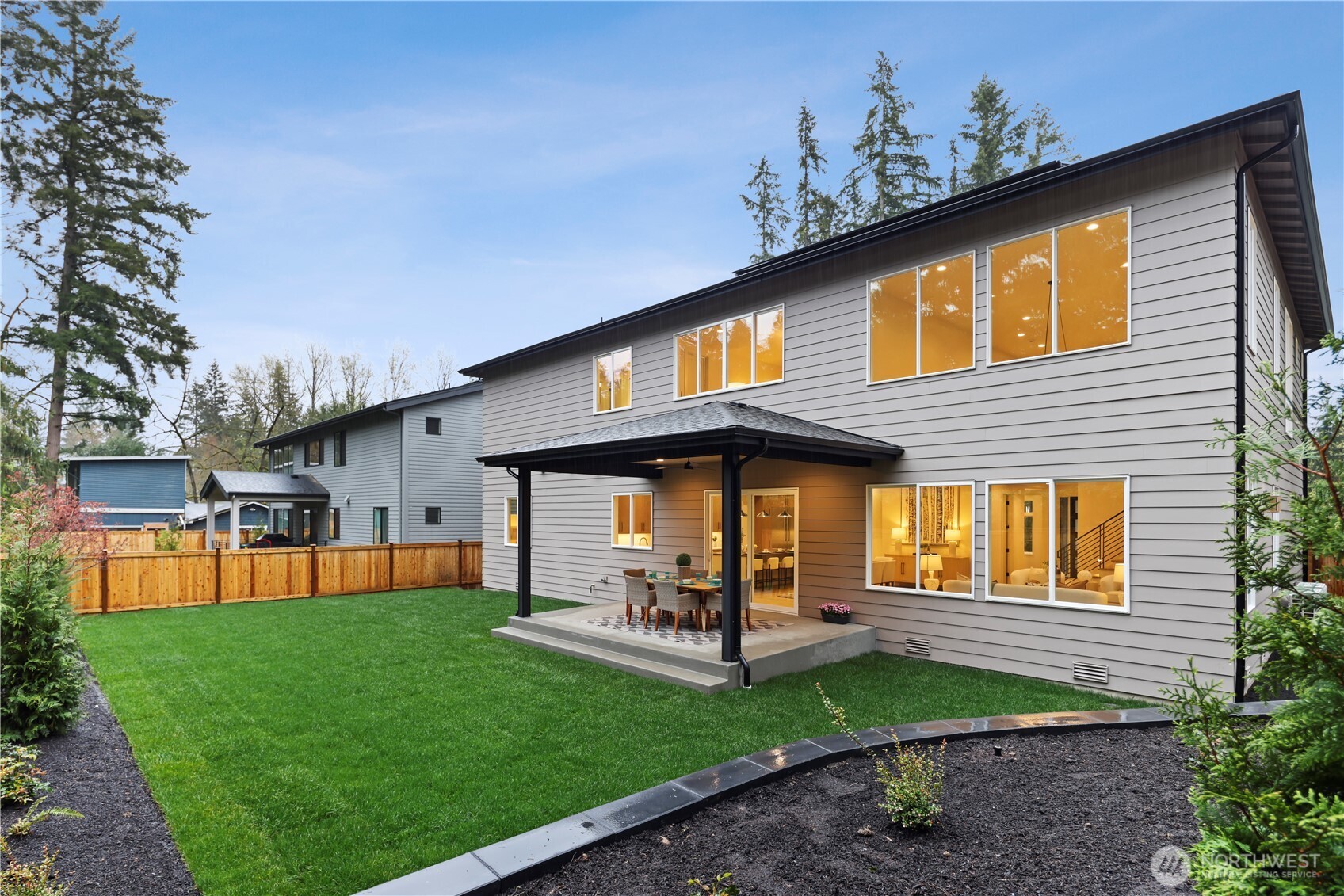 Level, fully-fenced yard with covered outdoor living. Raised bed would make a perfect summertime garden.