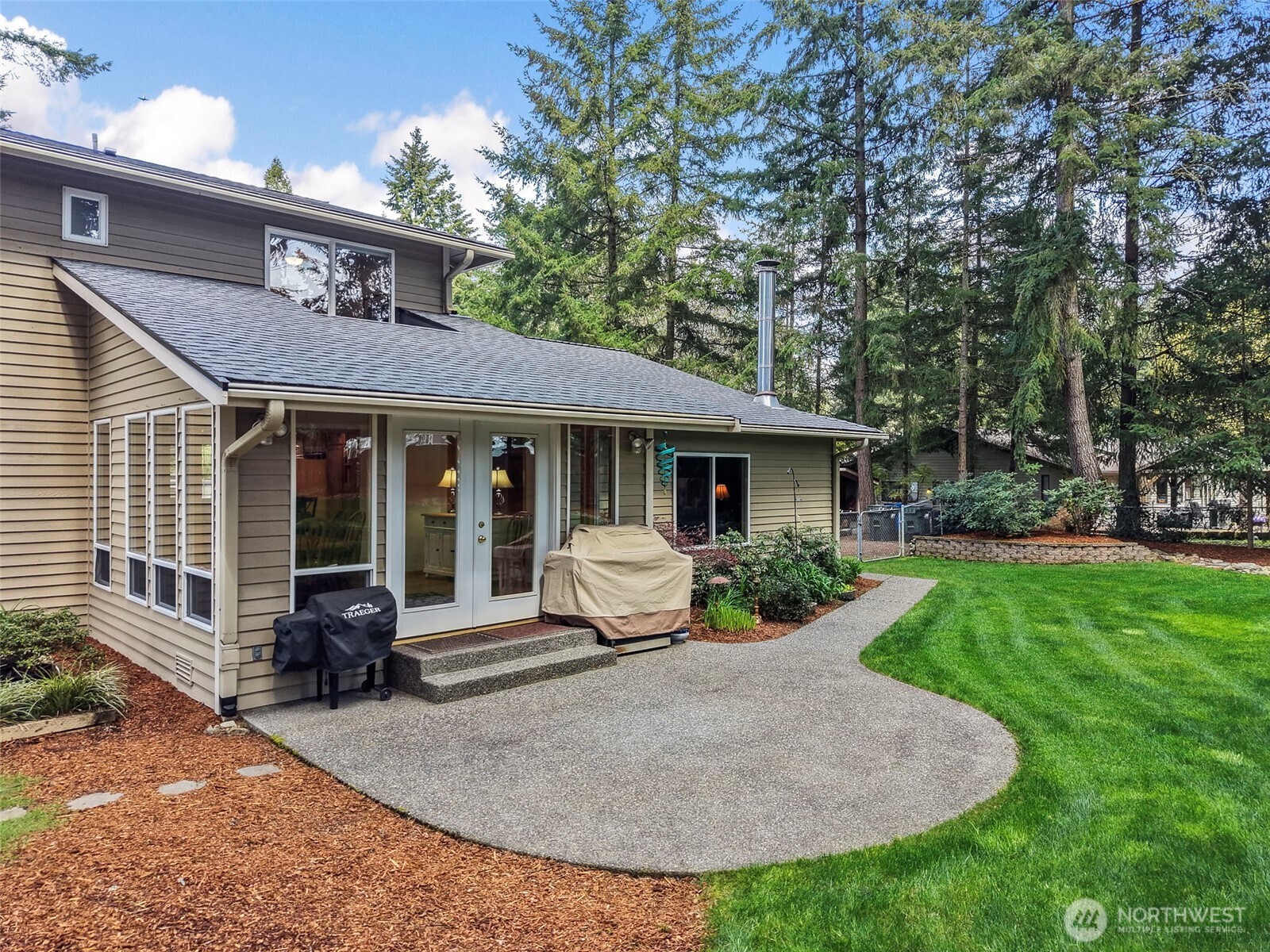 Mature landscaping and beautiful flowering plants/bushes all around