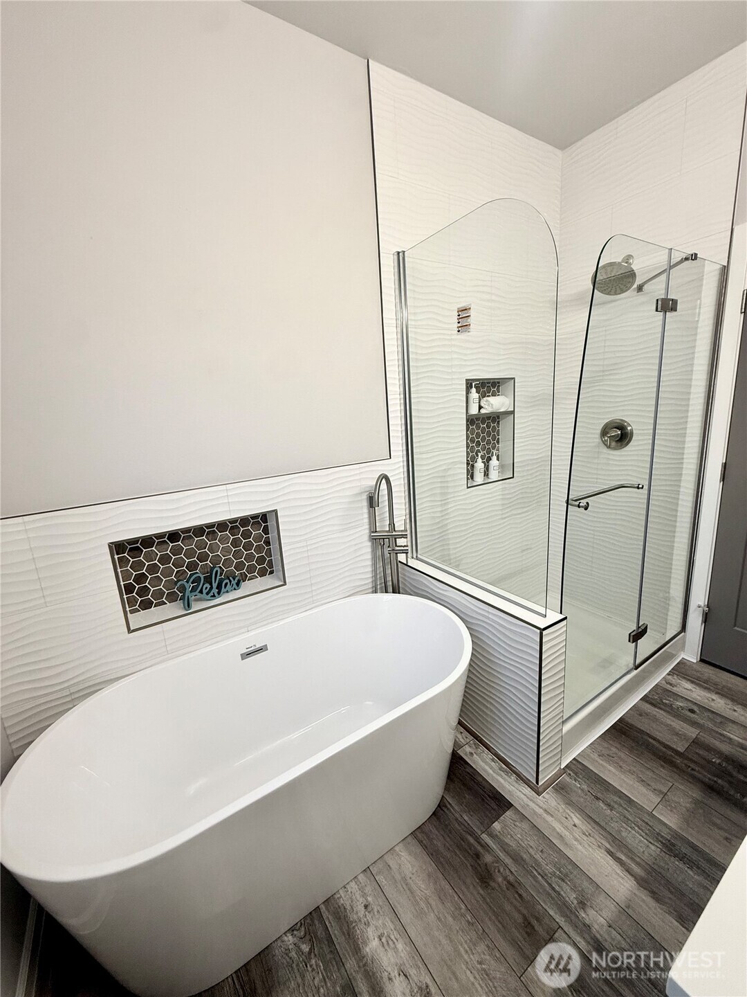 Downstairs primary suite large shower and soaking tub