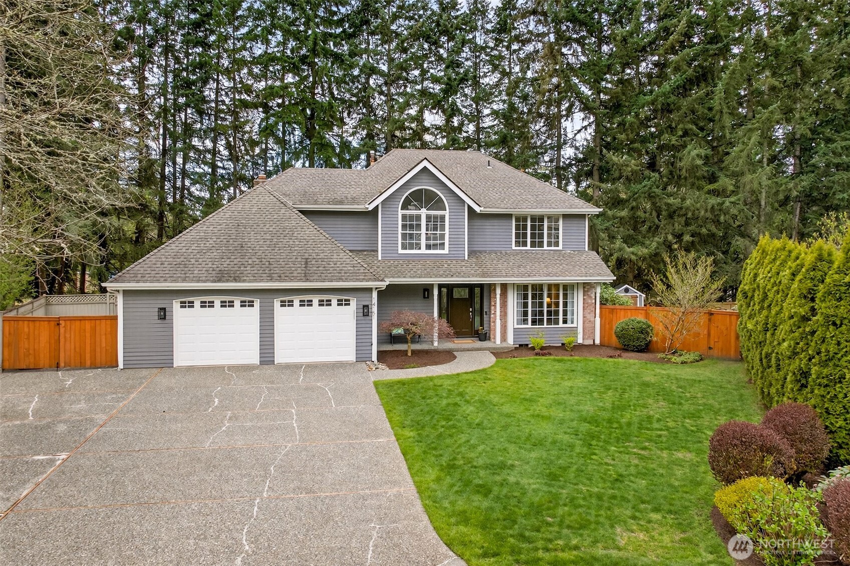Nestled among towering evergreens in the coveted Coventry on English Hill neighborhood, this well-proportioned two-story offers exceptional curb appeal with lush lawn and mature, private surroundings.
