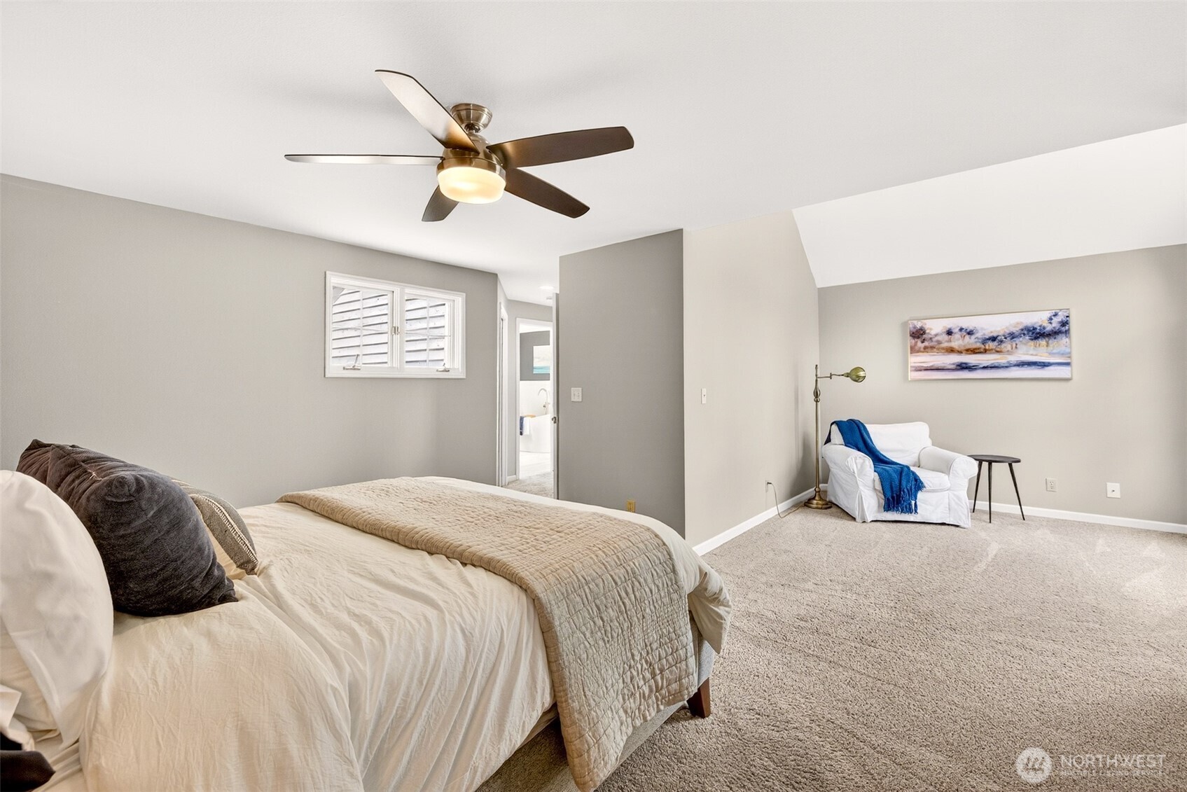The spacious primary bedroom offers room to truly unwind — with plush carpet, a ceiling fan, plantation shutters, and a private ensuite just steps away, this is a retreat designed for everyday comfort.