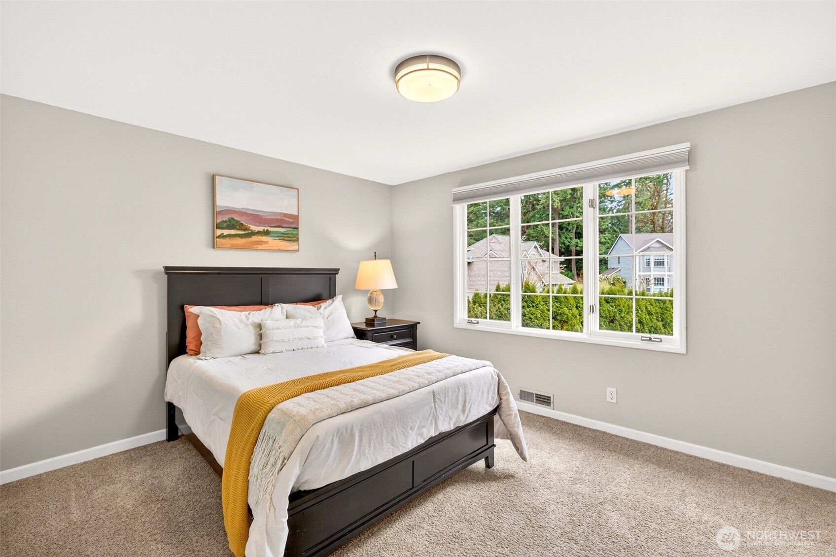 The third bedroom offers a bright, welcoming space with a large picture window overlooking the lush Coventry neighborhood streetscape — a comfortable and versatile room with excellent natural light.