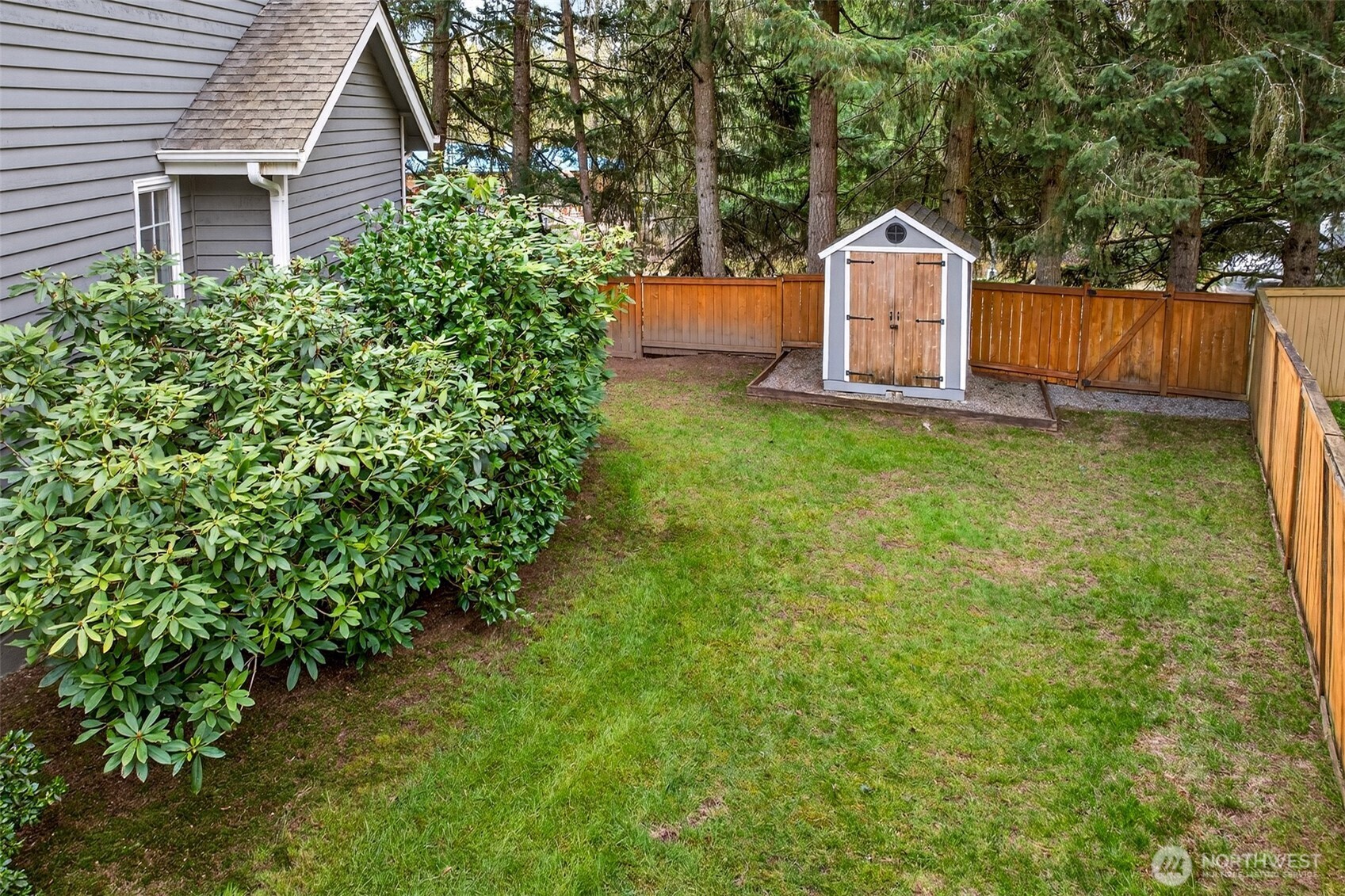 A detached storage shed tucked into the corner of the fenced backyard offers convenient extra storage for tools, outdoor equipment, or garden supplies — a practical bonus on an already generous 11,257 SF lot.