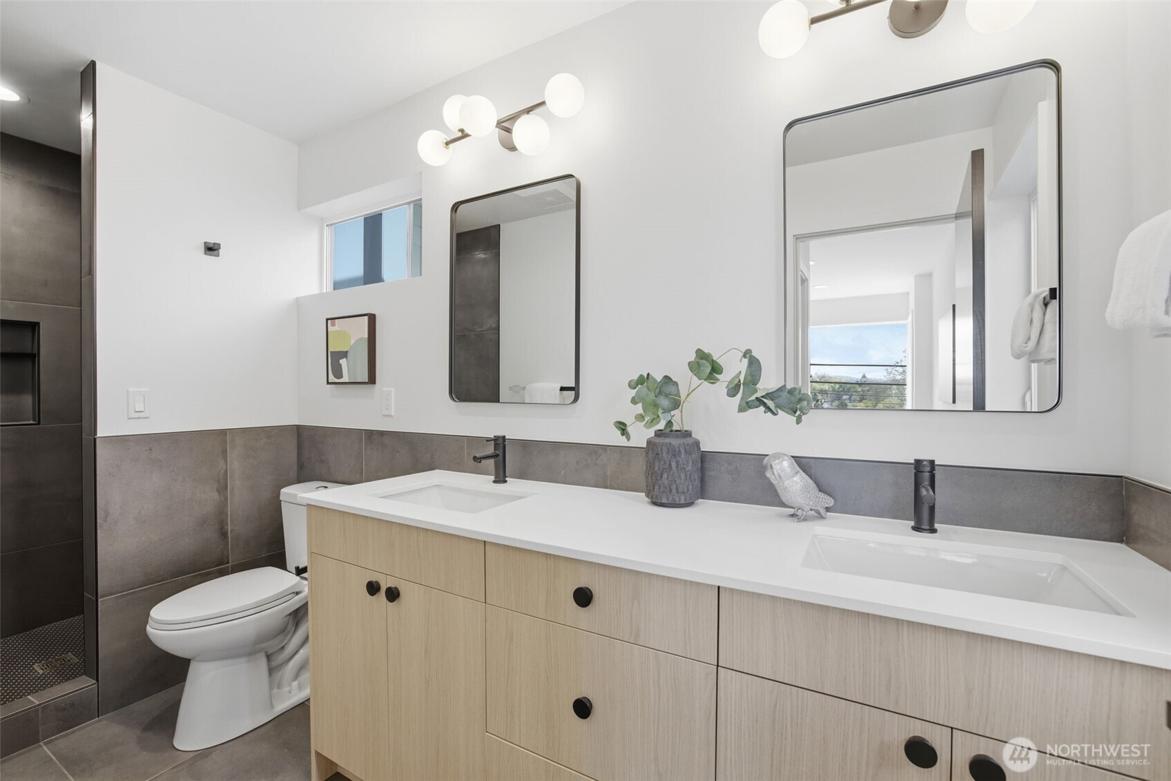 Spa-inspired primary bathroom with double vanity, quartz countertops, designer tile shower, and luxury new construction finishes.