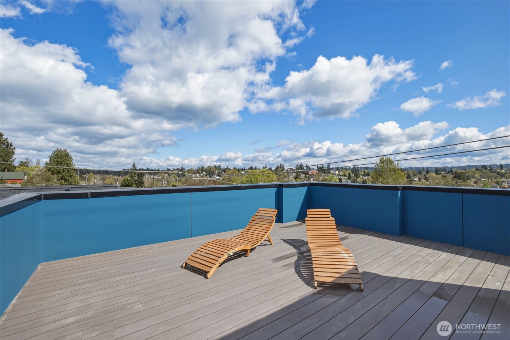 Private rooftop deck with panoramic Seattle views, blue-sky outlooks, and space to lounge, entertain, or enjoy sunset evenings.