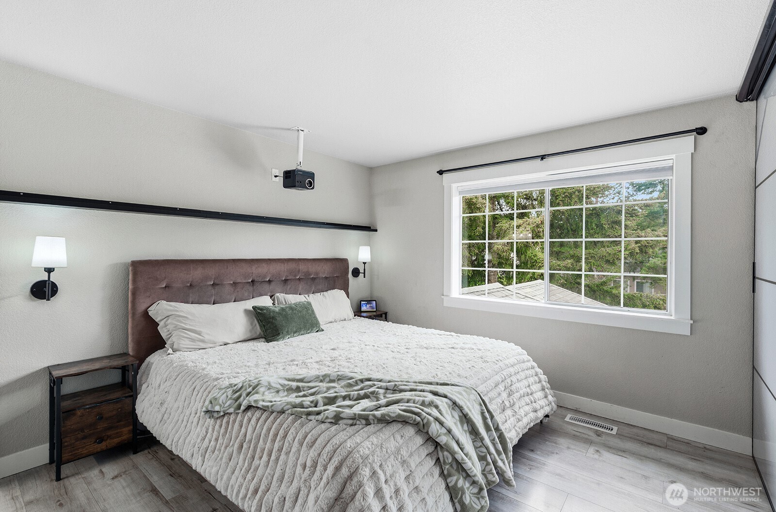 Primary suite with hard surface flooring and oversized window.